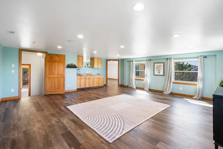 Living room featuring dark wood-style floors and recessed lighting