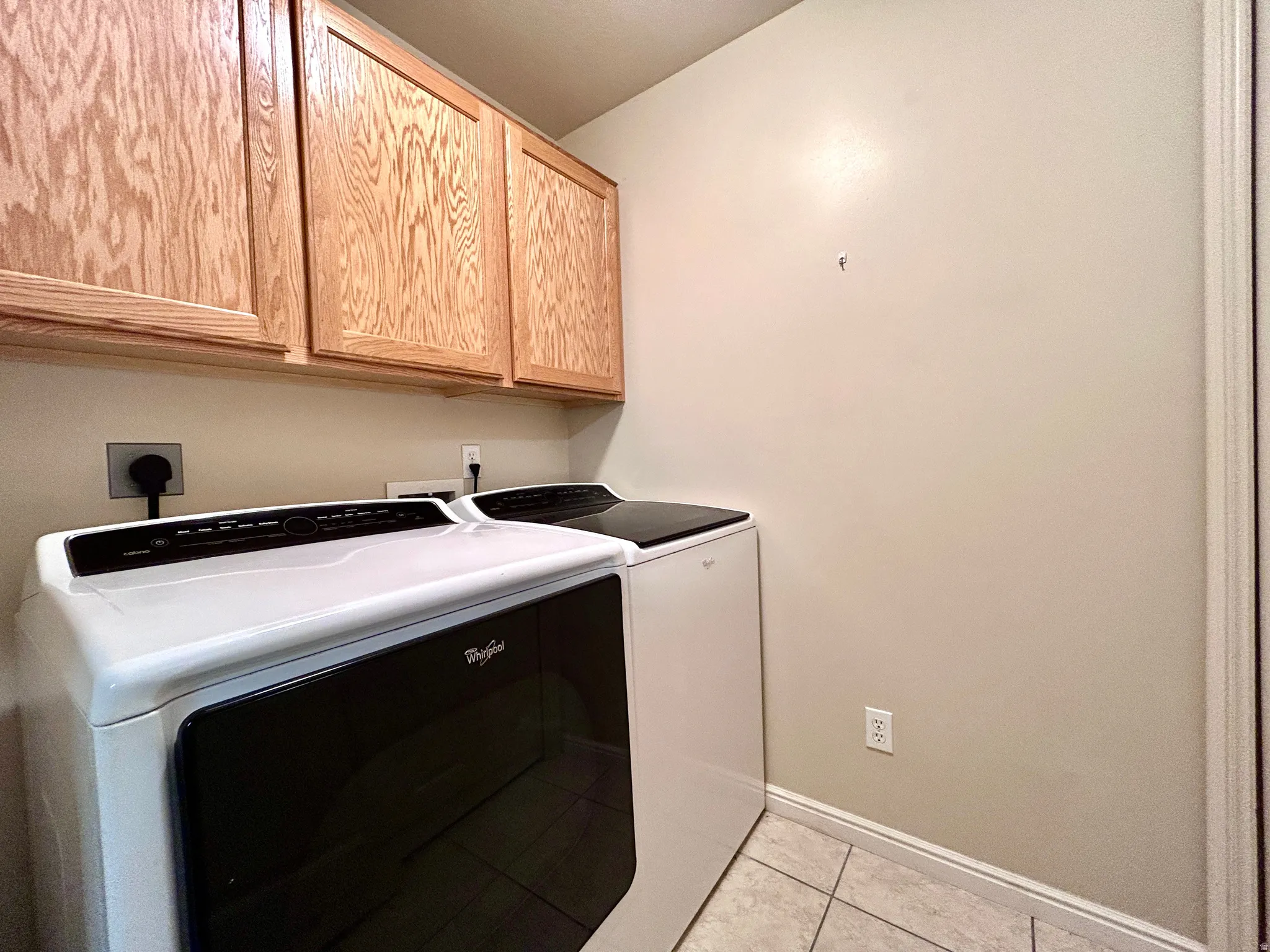 Laundry room with additional cabinets. The furnace and water heater are in a separate closet in this room.