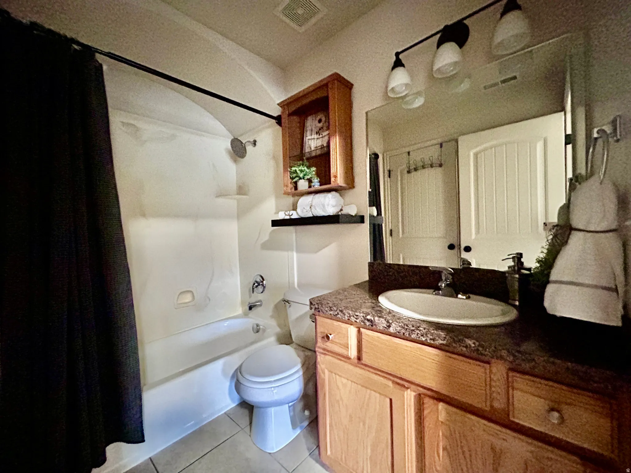 The full bath upstairs has two entrances - one leading to the primary bedroom and the other to the hallway.