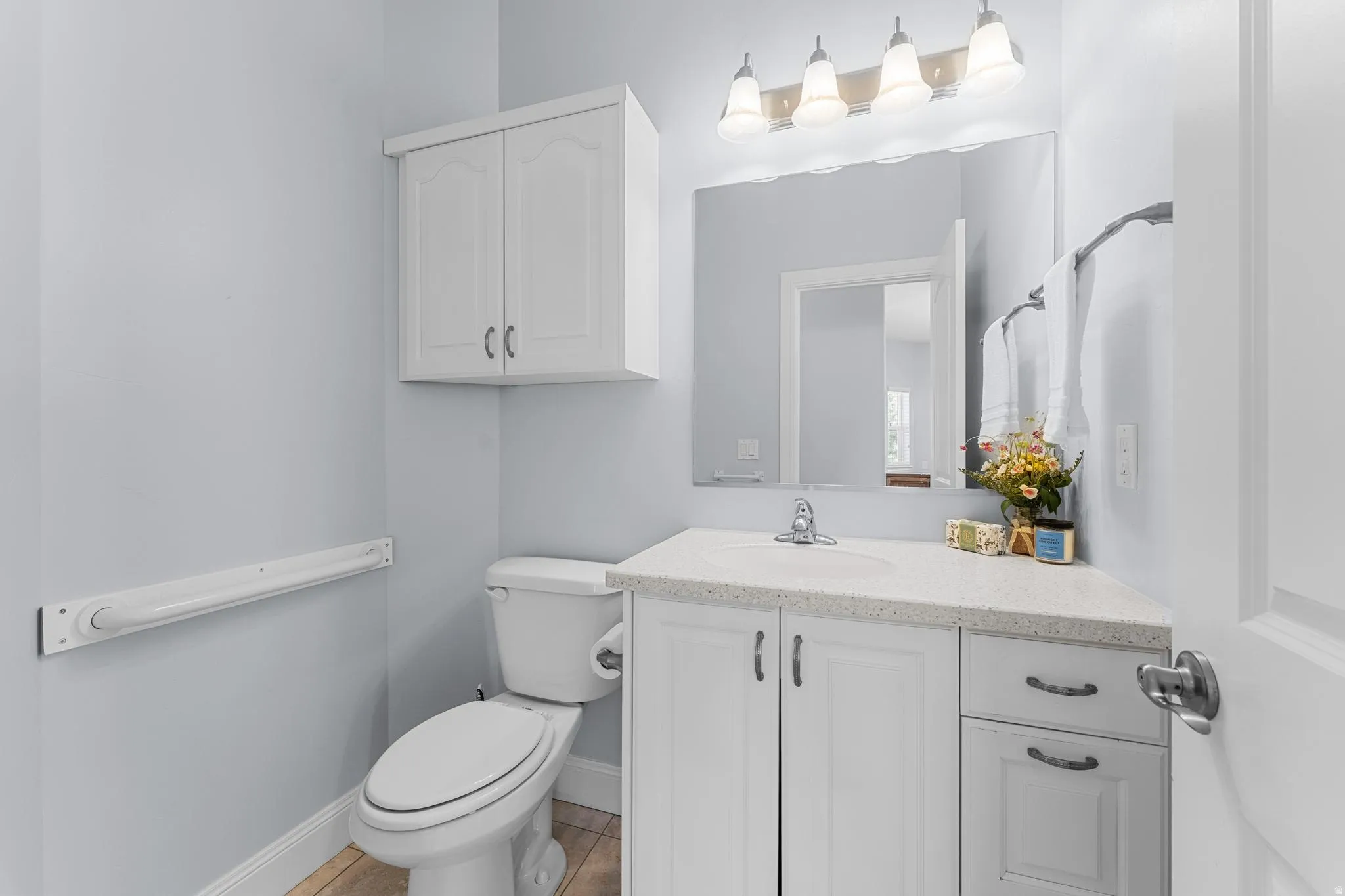 Guest Bathroom featuring vanity and light tile patterned floors