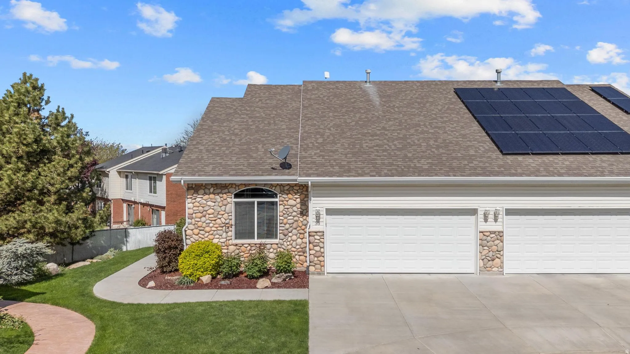View of front of home featuring stone siding and attached 2 car garage