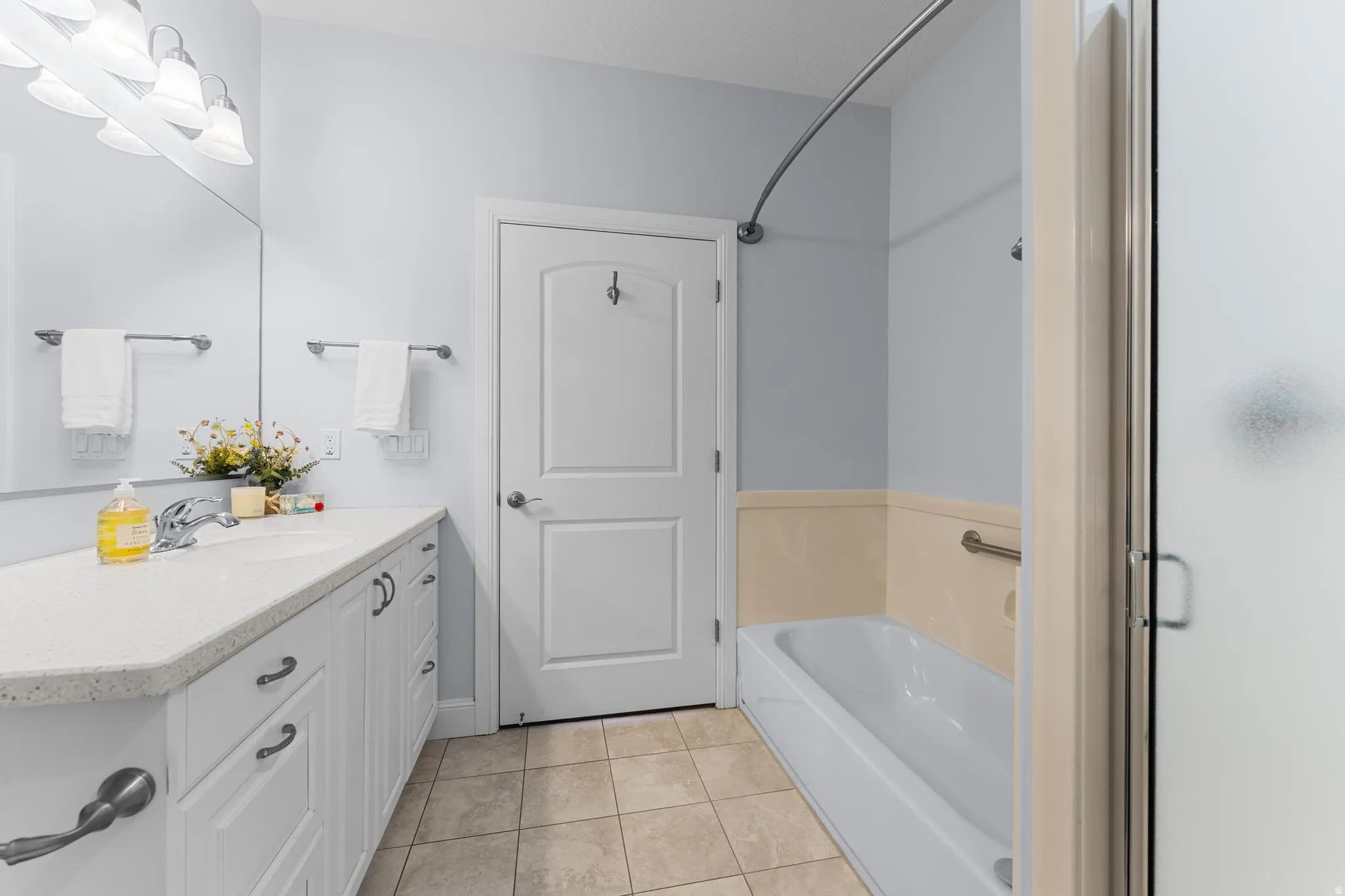 Main Bathroom featuring vanity, tile floors and separate tub