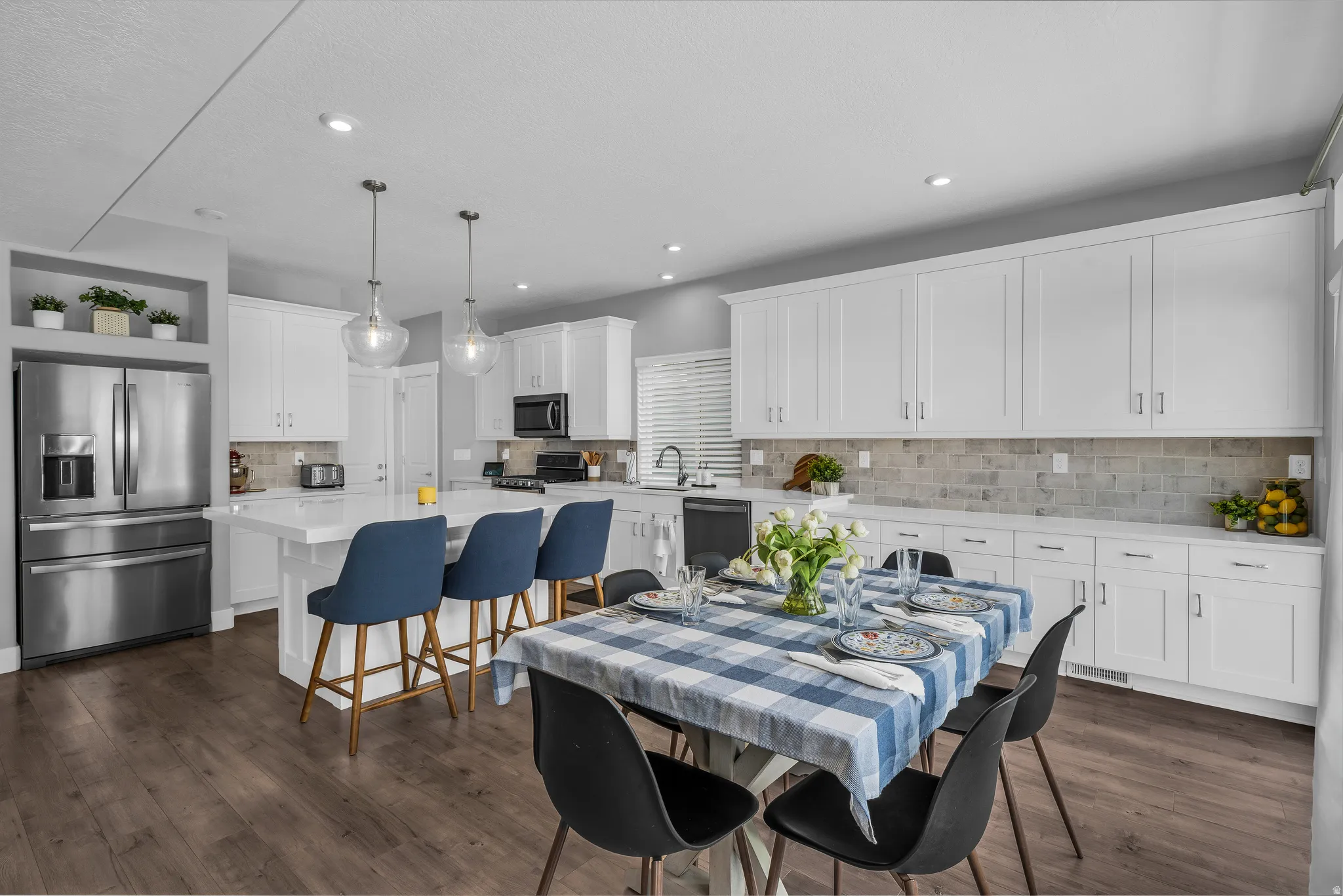 Dining space with dark wood-type flooring and recessed lighting
