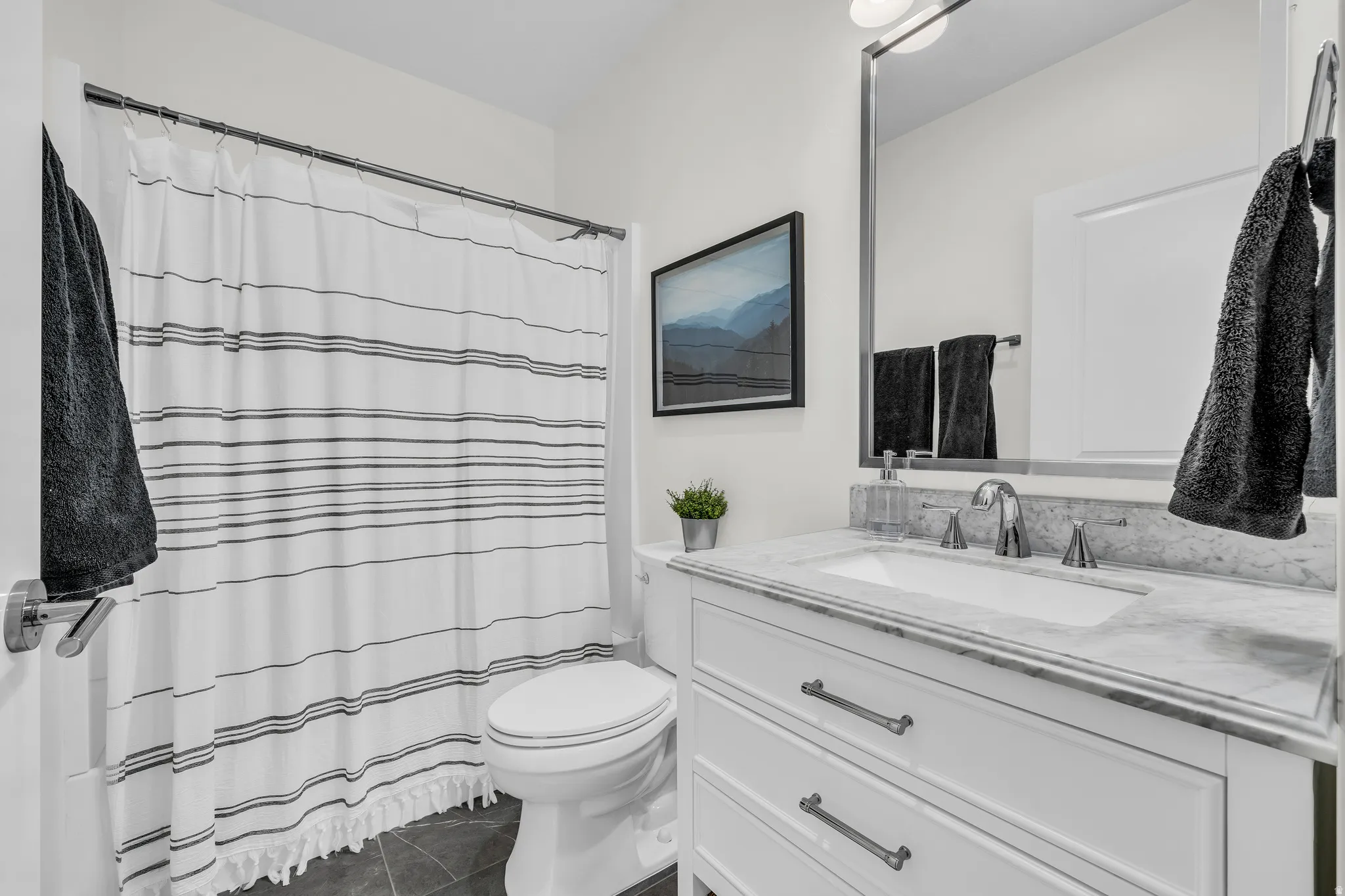Full bath featuring vanity and a shower with shower curtain