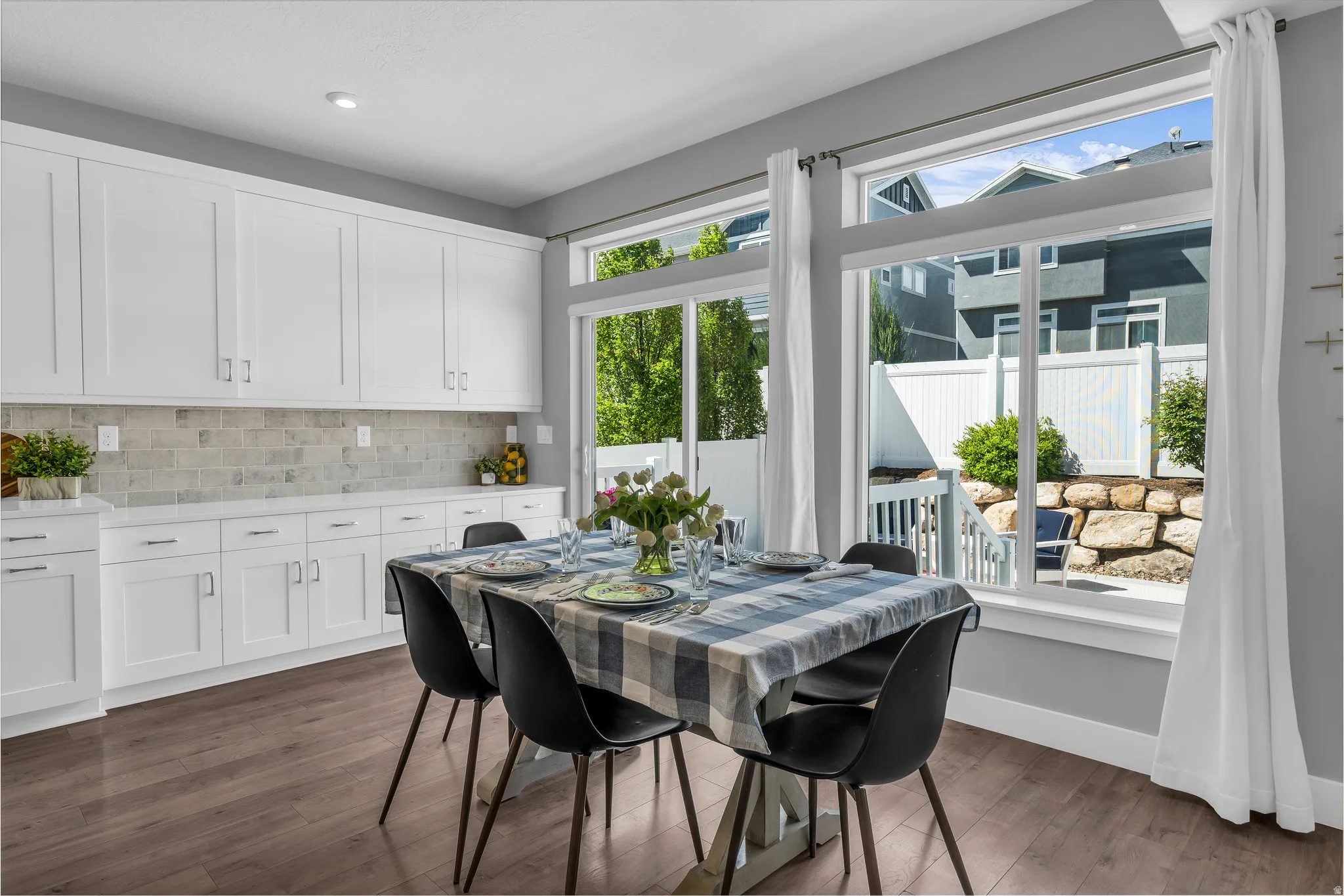 Dining room with dark wood-style floors and recessed lighting