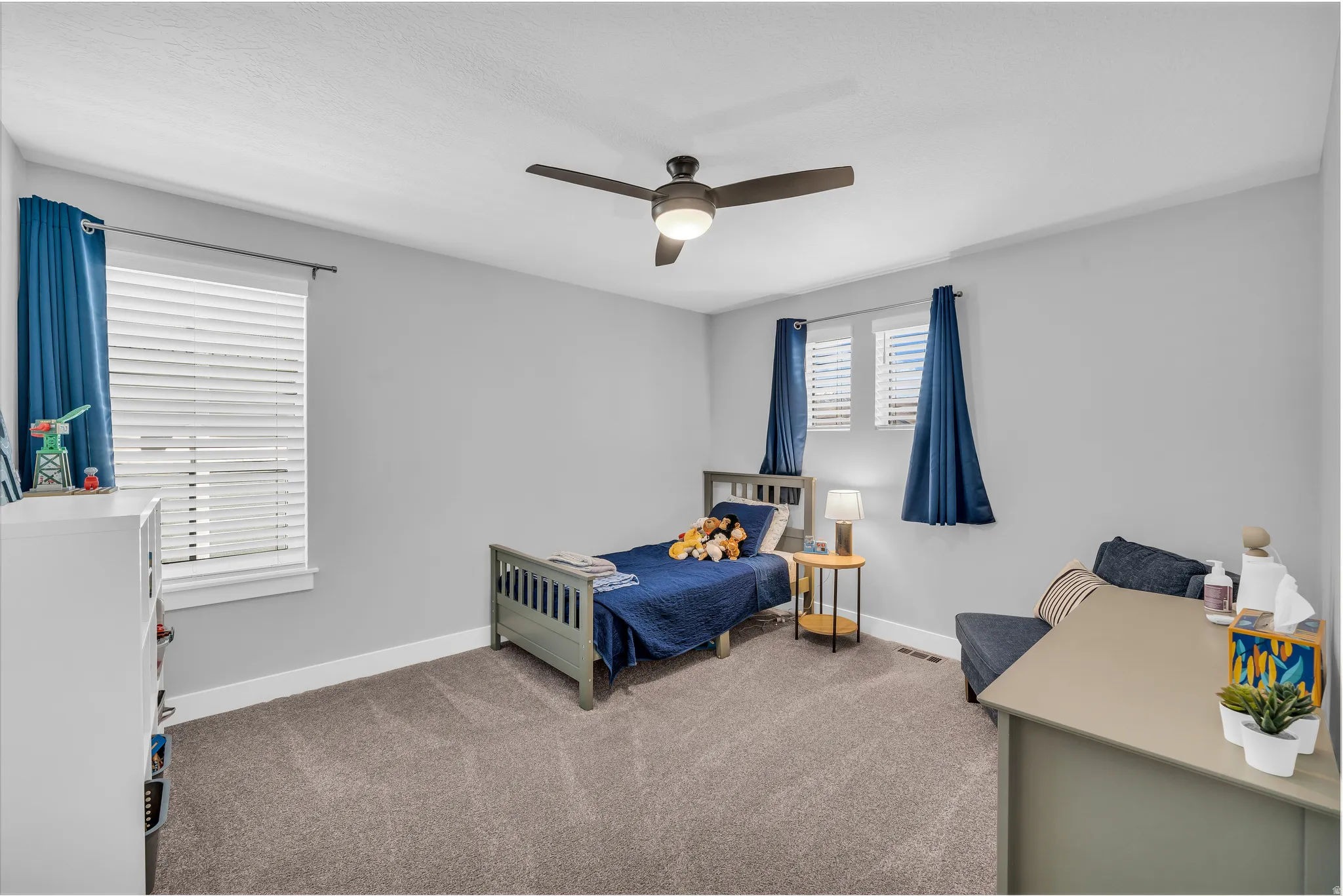 Bedroom featuring light carpet and ceiling fan