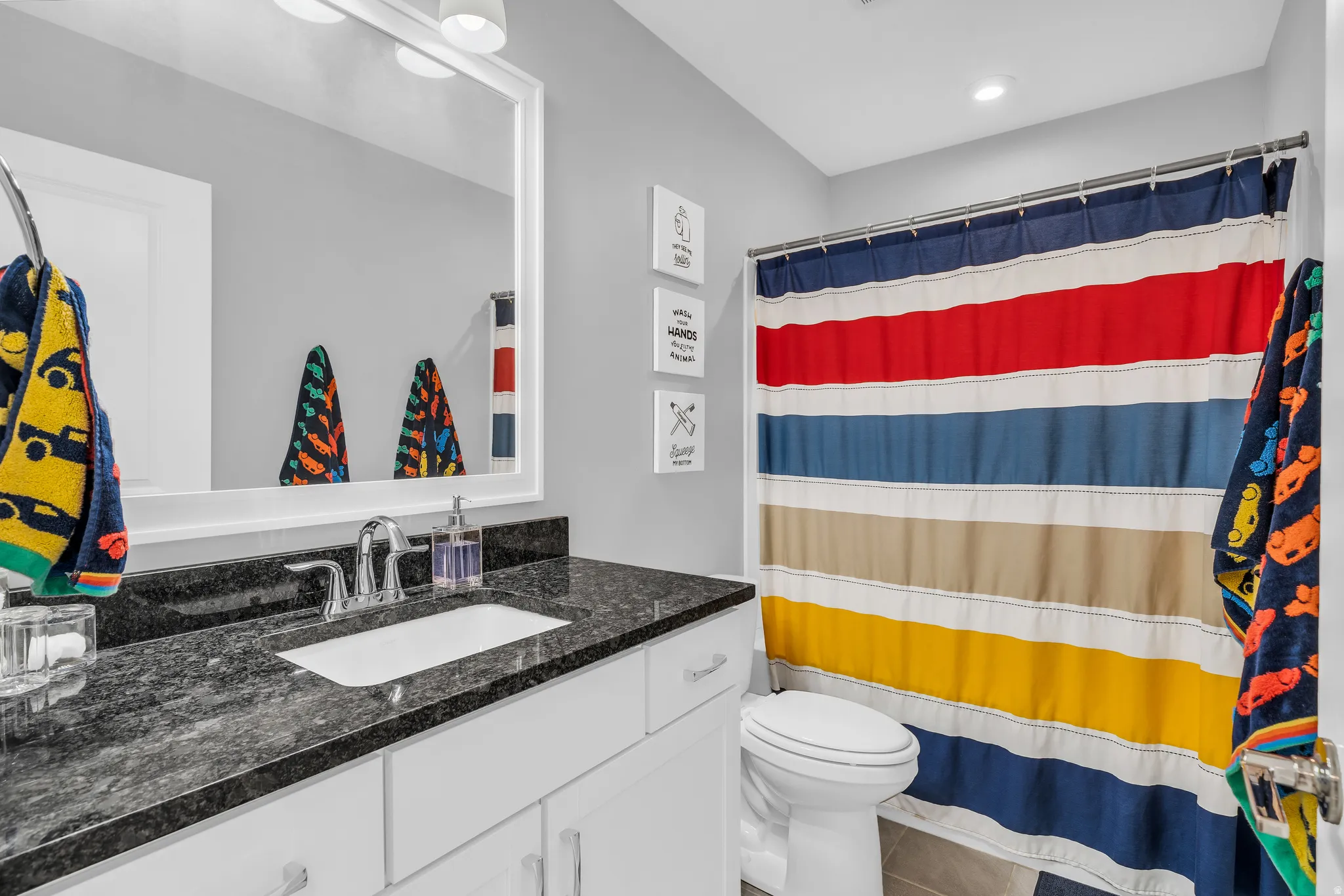 Full bathroom featuring vanity, a shower with curtain, and tile patterned flooring