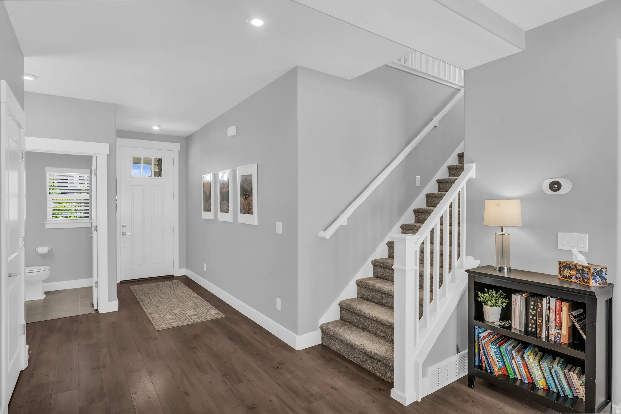 Entryway with dark wood finished floors and recessed lighting