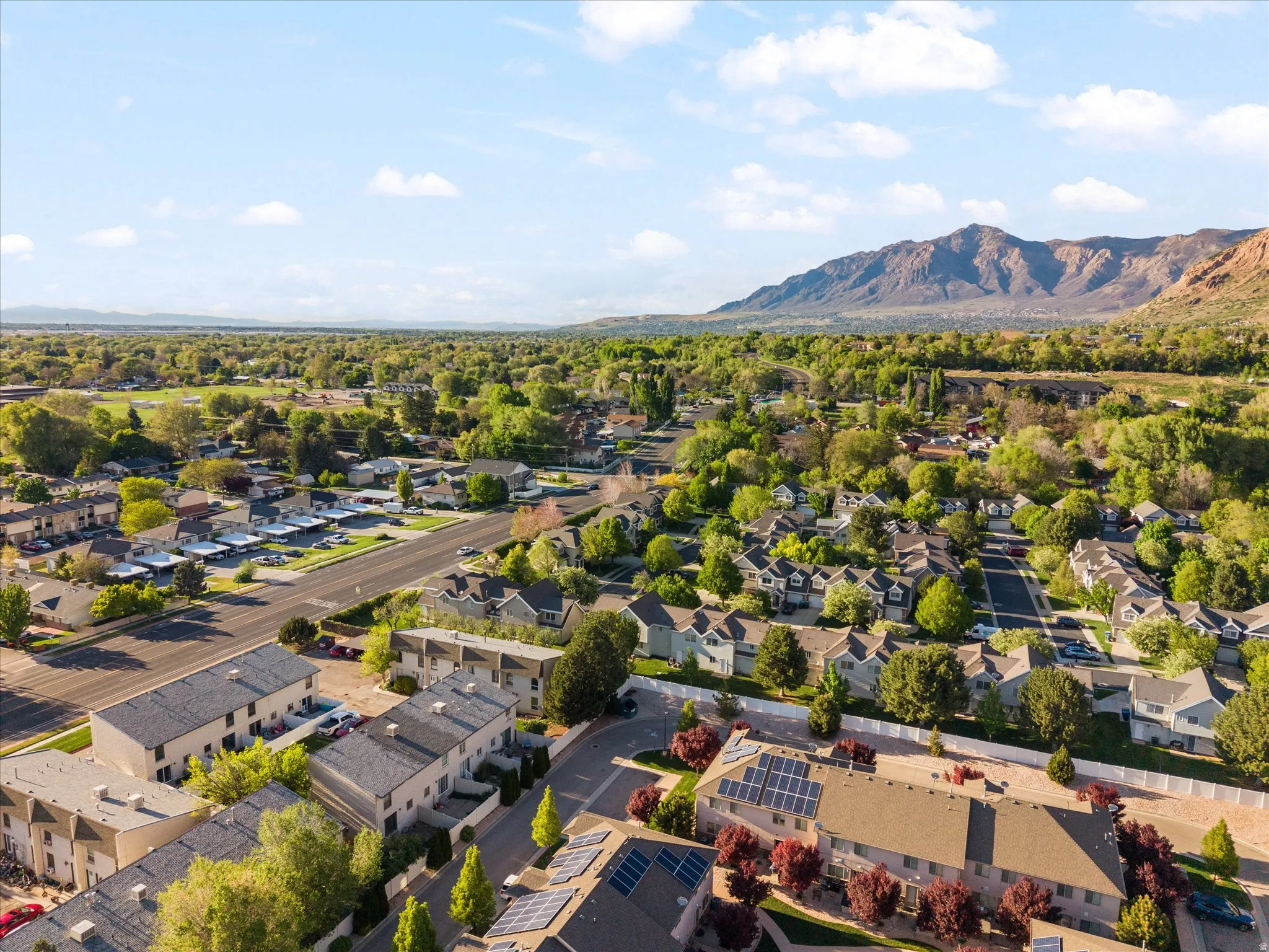 Aerial perspective of suburban area with a mountainous background