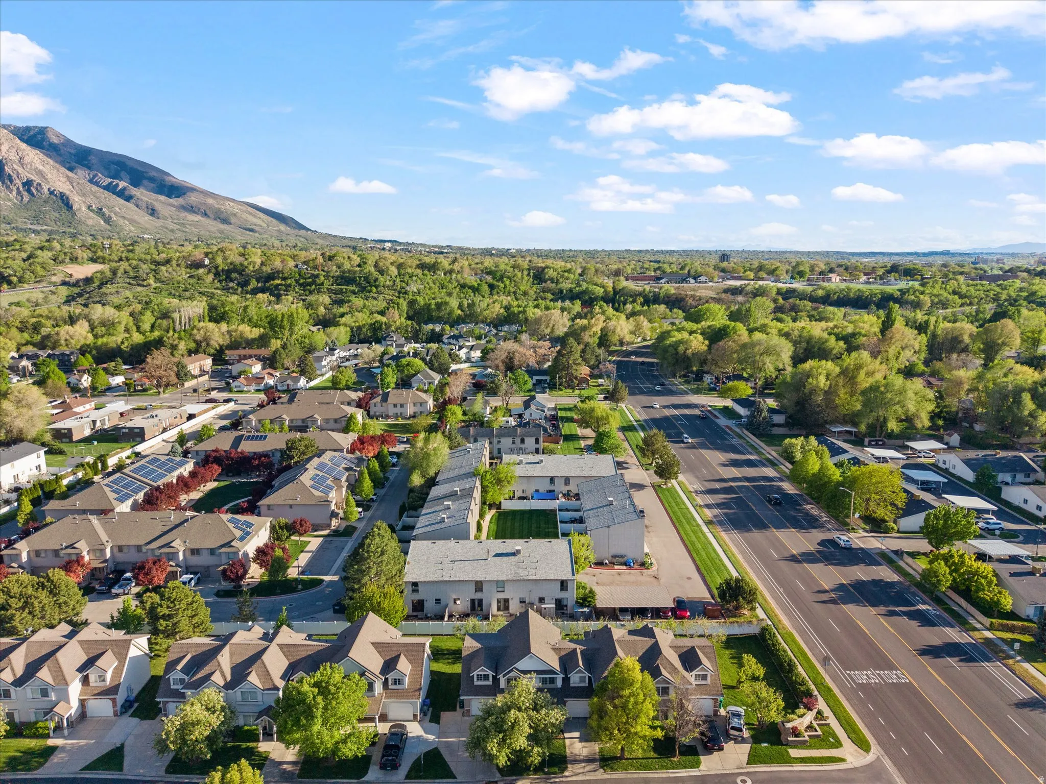 Aerial view of residential area featuring a mountainous background