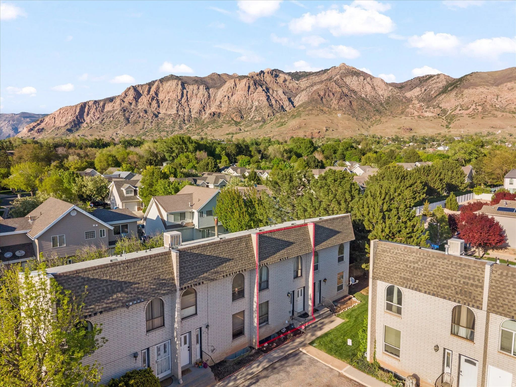 Aerial perspective of suburban area featuring a mountain backdrop