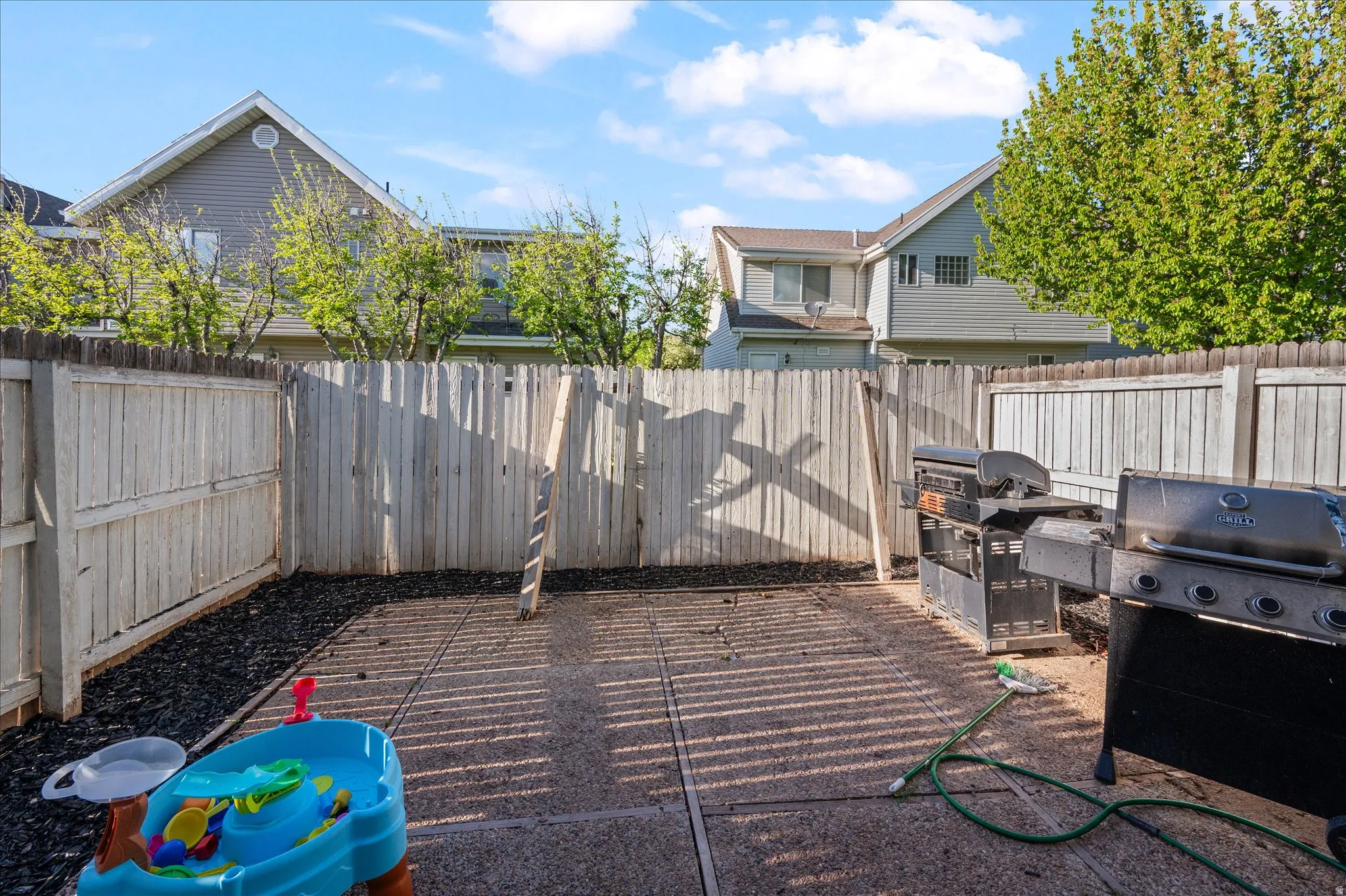 Fenced backyard featuring grilling area