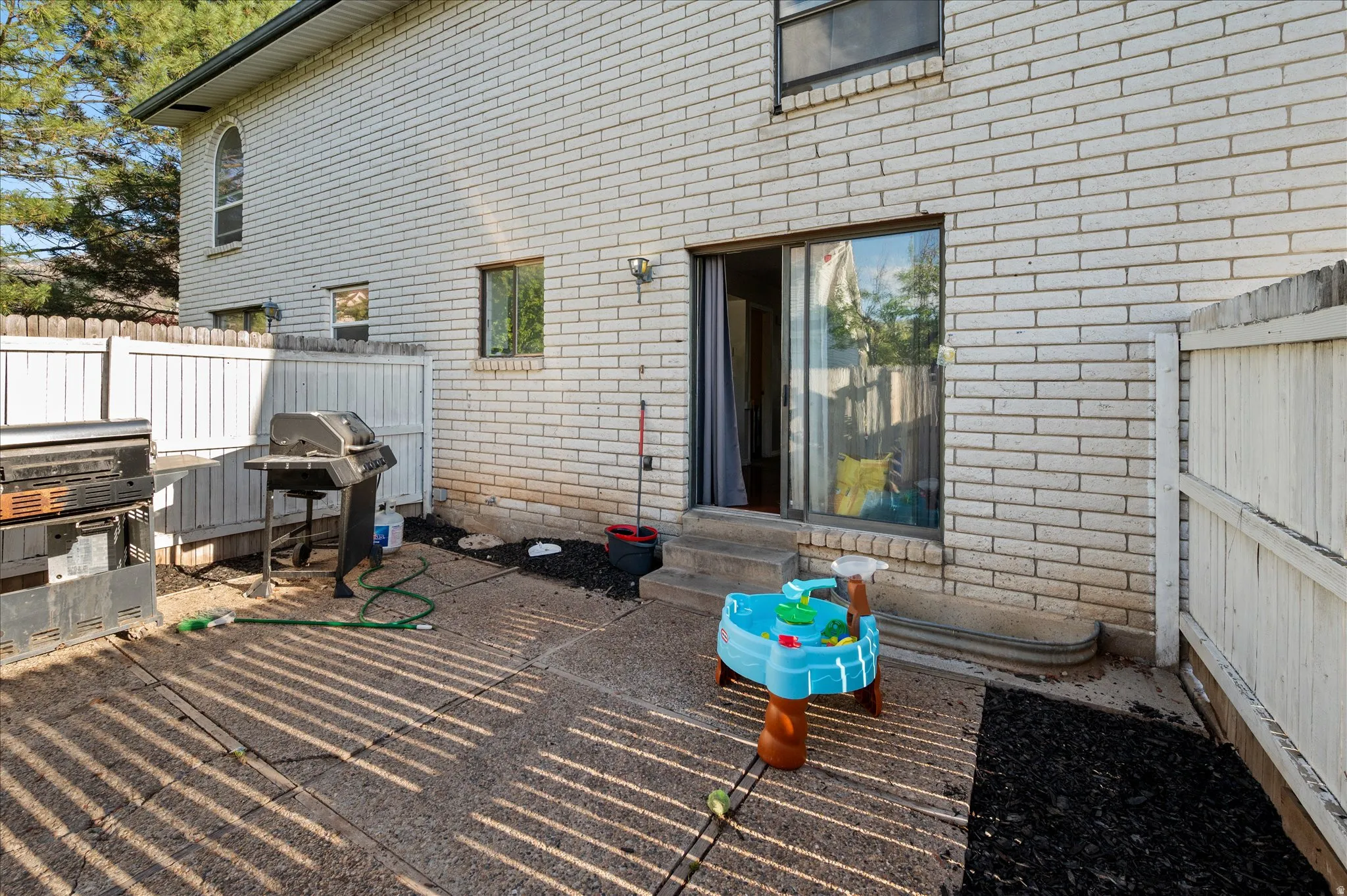 View of patio / terrace featuring entry steps and a grill