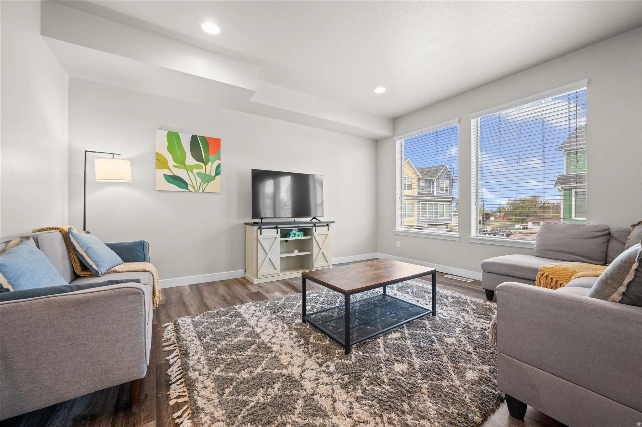 Living room with wood finished floors and recessed lighting