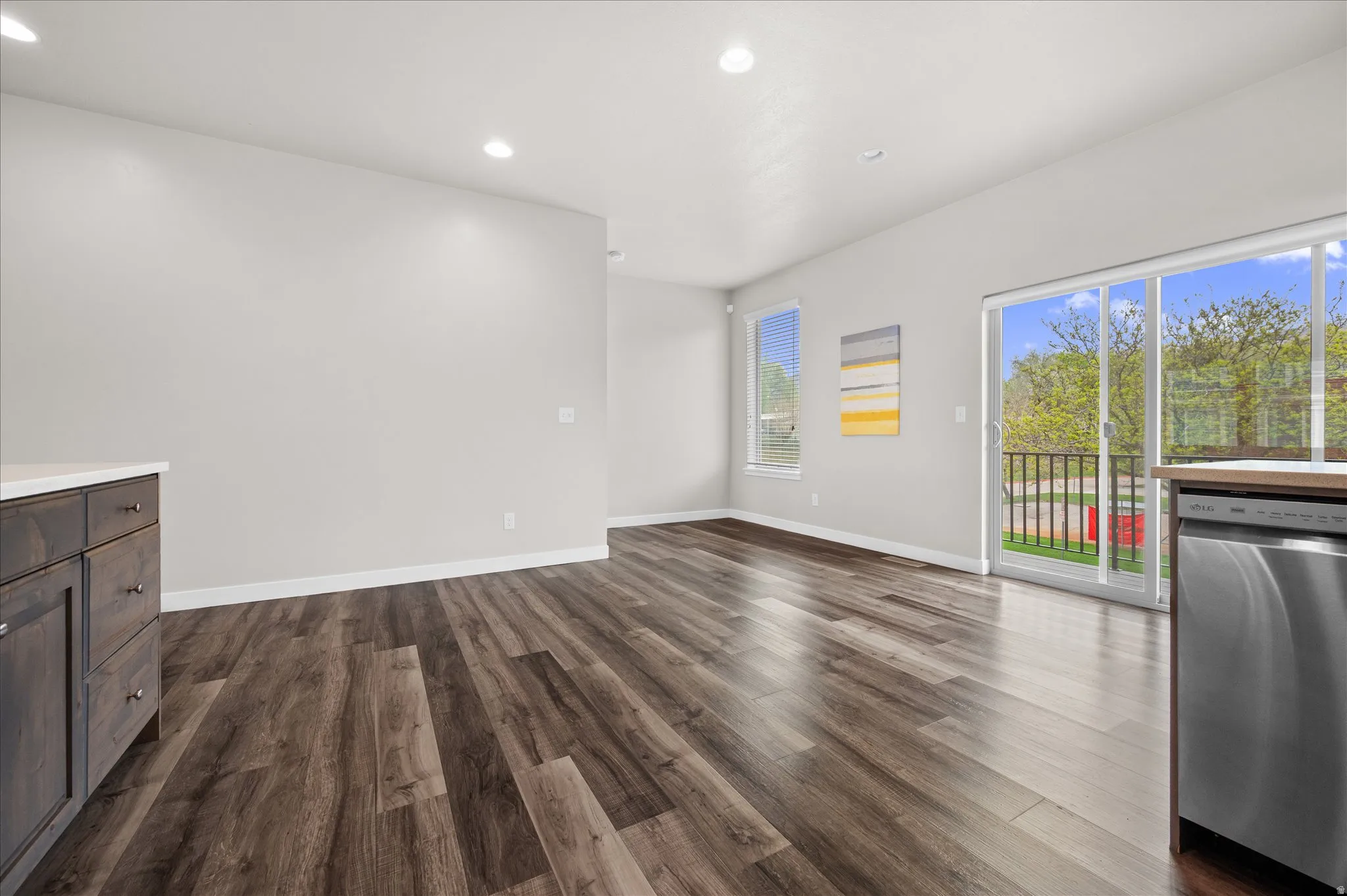 Unfurnished living room featuring recessed lighting and dark wood-style flooring
