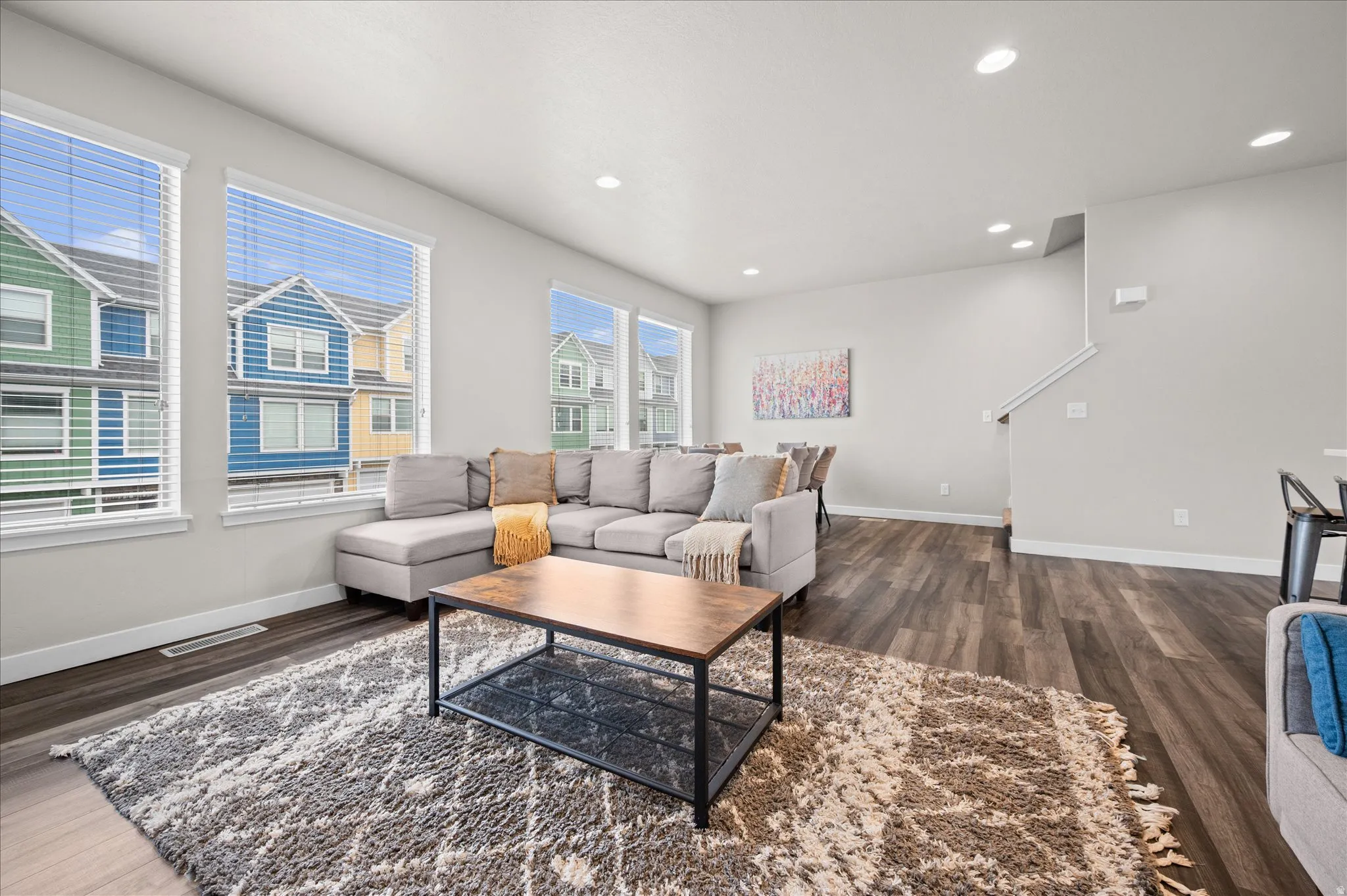Living area featuring dark wood-style floors and recessed lighting