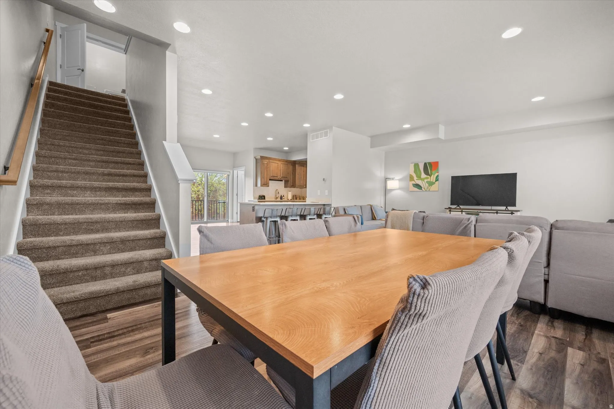 Dining area featuring dark wood finished floors and recessed lighting