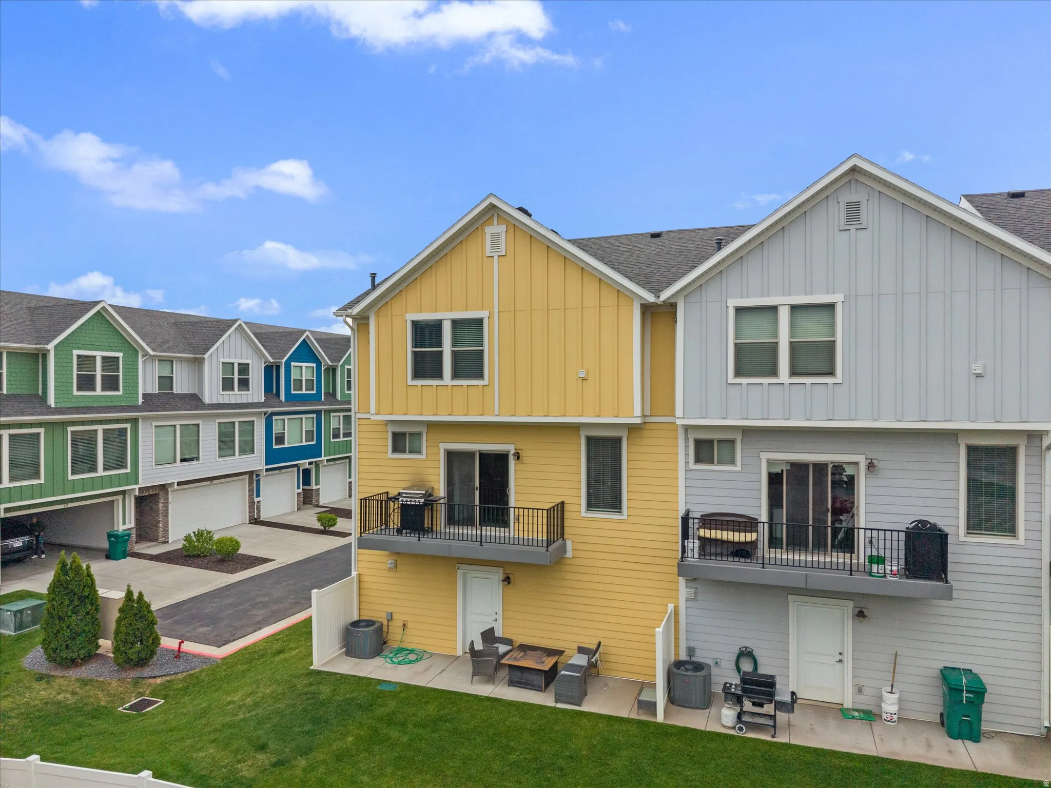 Back of property with a patio area, board and batten siding, and a residential view