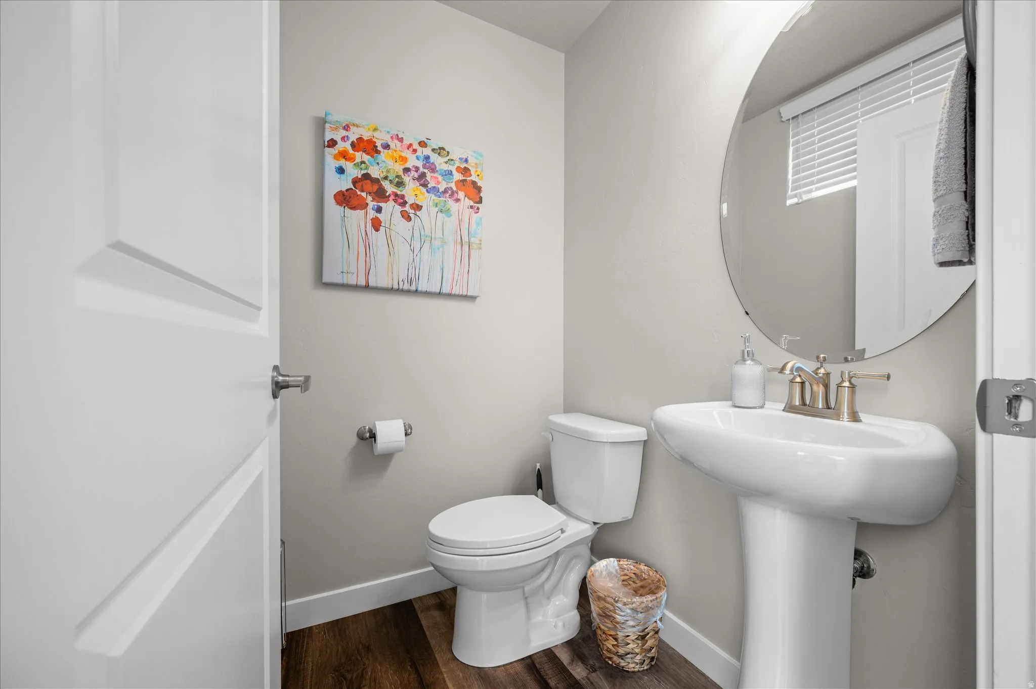 Half bathroom with toilet and dark wood-type flooring