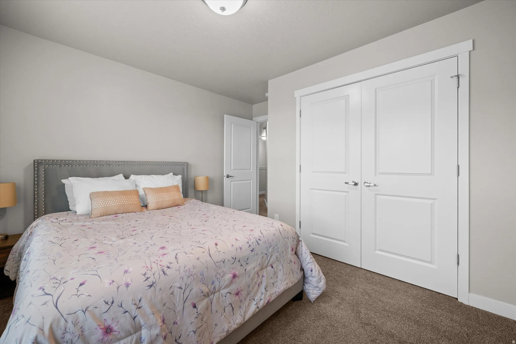 Bedroom featuring dark carpet and a closet