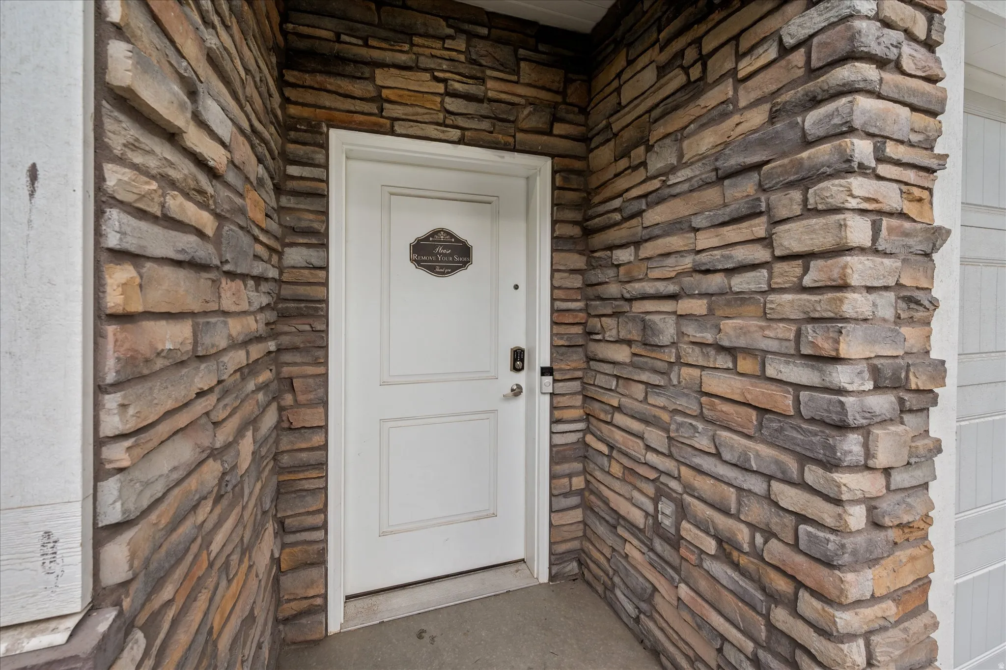 View of exterior entry with stone siding