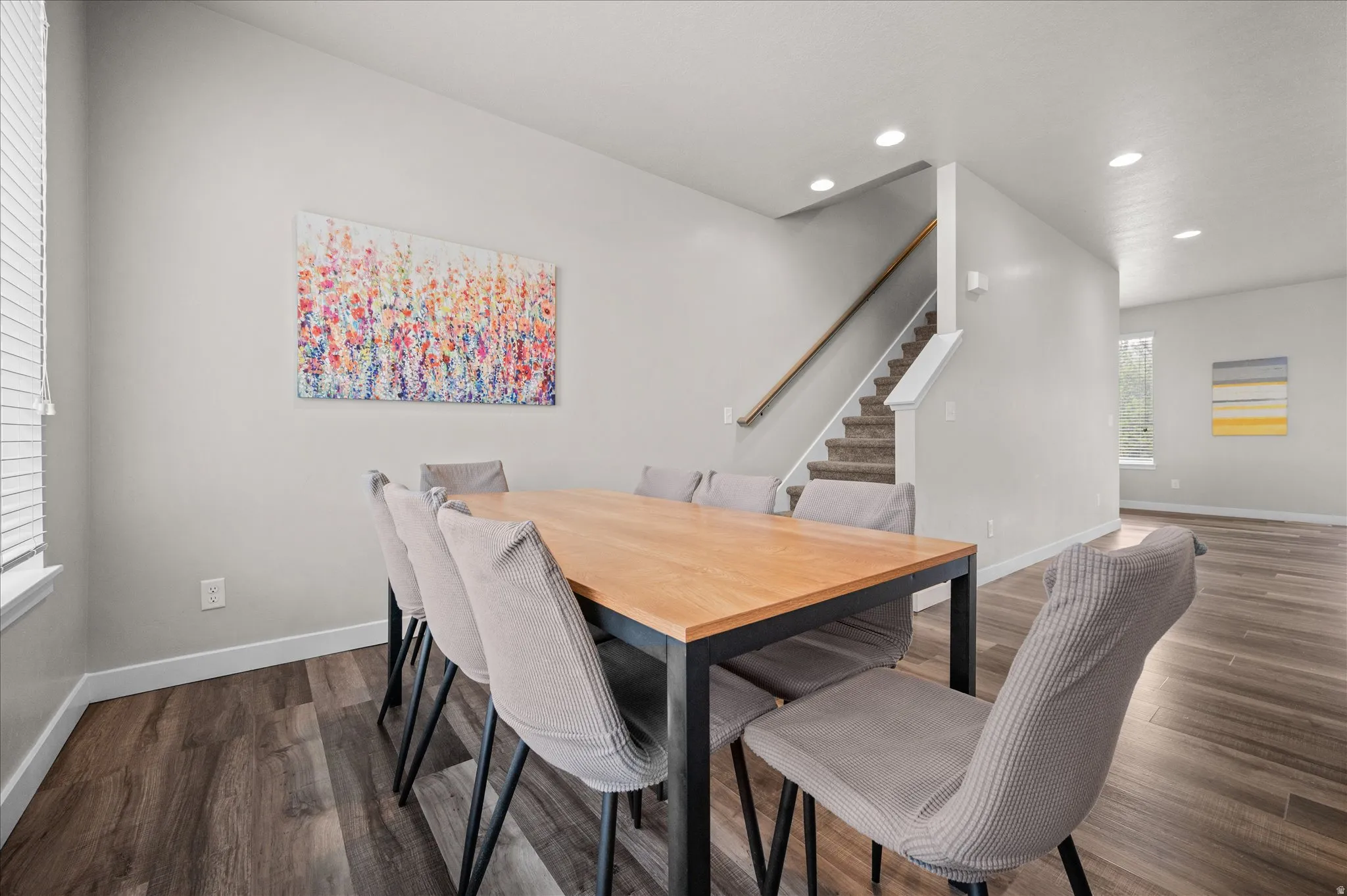Dining area featuring dark wood finished floors and recessed lighting