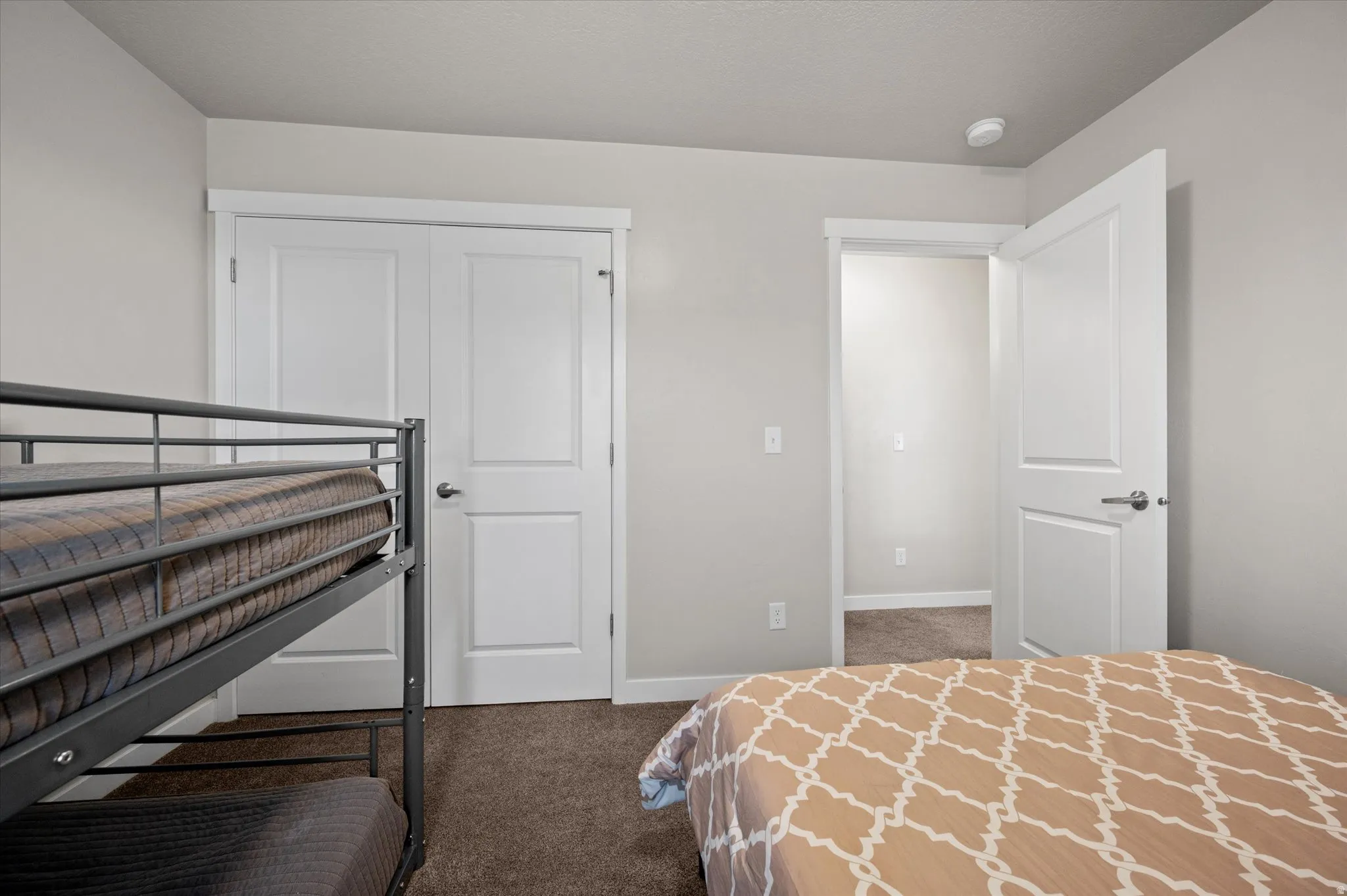 Bedroom featuring dark carpet and a closet