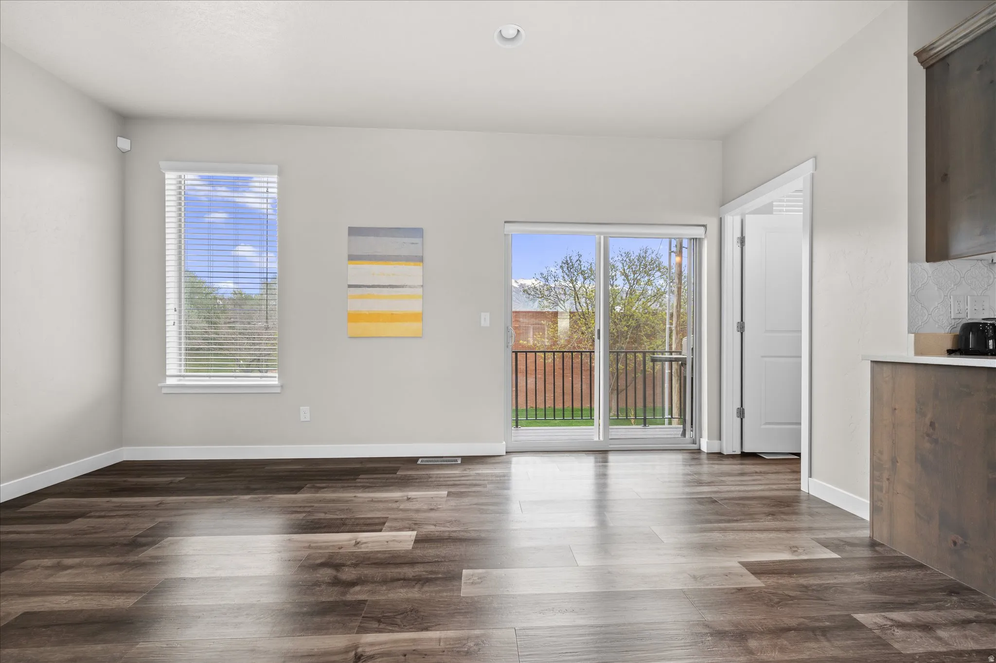 Unfurnished dining area with dark wood-style floors and recessed lighting