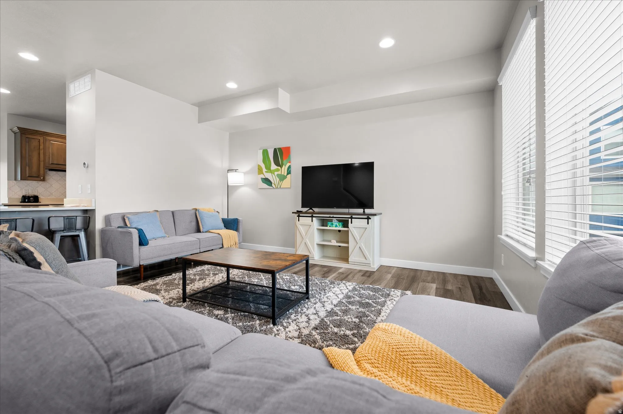 Living room with wood finished floors and recessed lighting