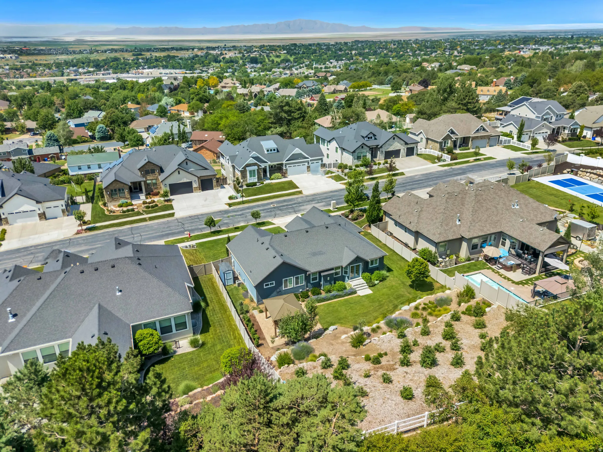 Aerial perspective of suburban area featuring a mountain backdrop