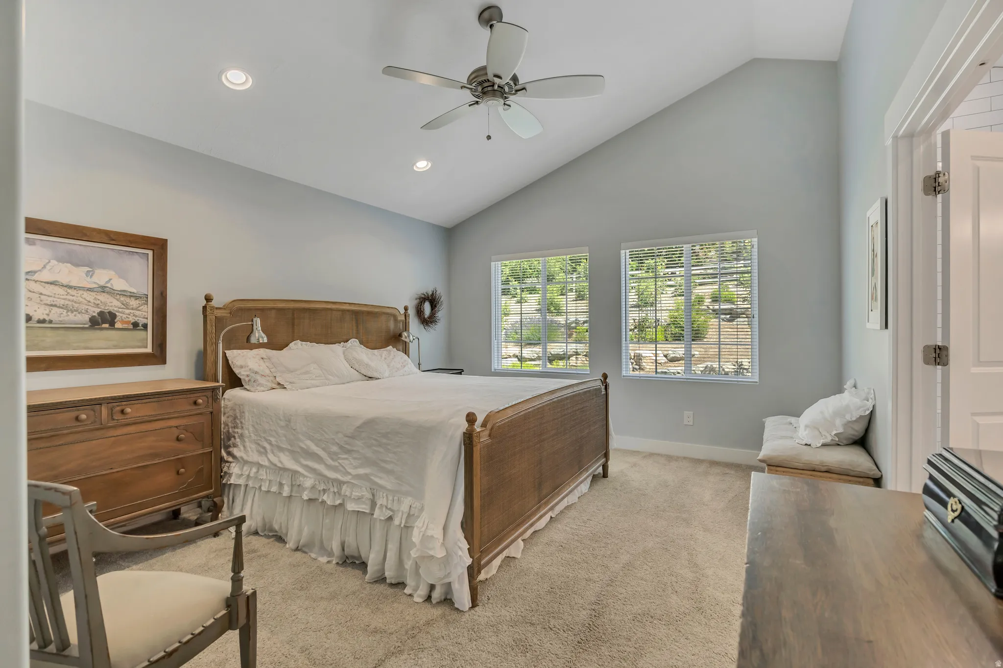 Bedroom with vaulted ceiling, light carpet, ceiling fan, and recessed lighting
