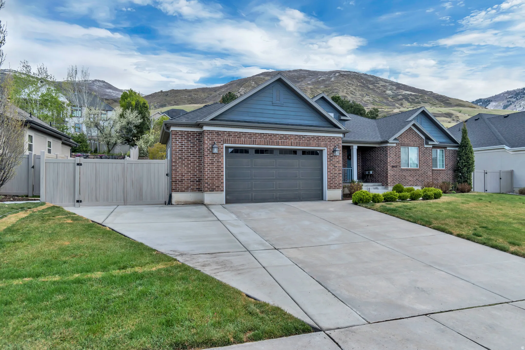 Exterior photo of home with RV Parking and double-wide privacy gate.