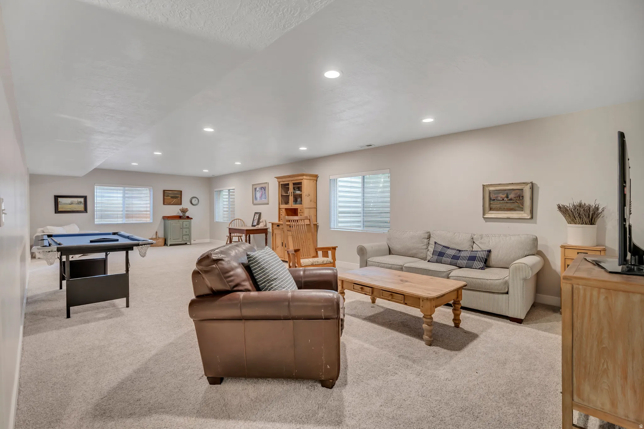 Living room with carpet, recessed lighting, and billiards