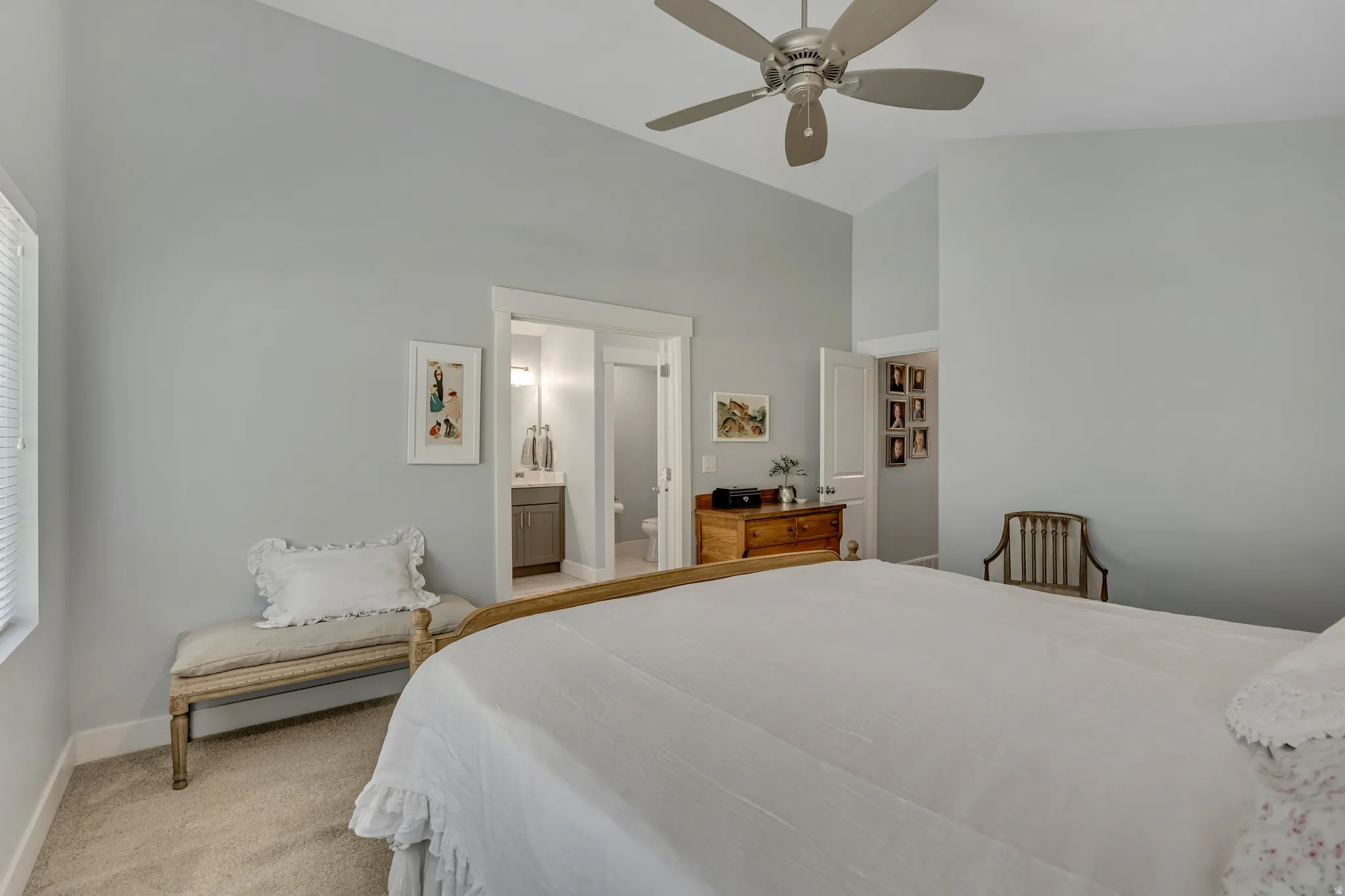Bedroom featuring light carpet, a ceiling fan, and lofted ceiling