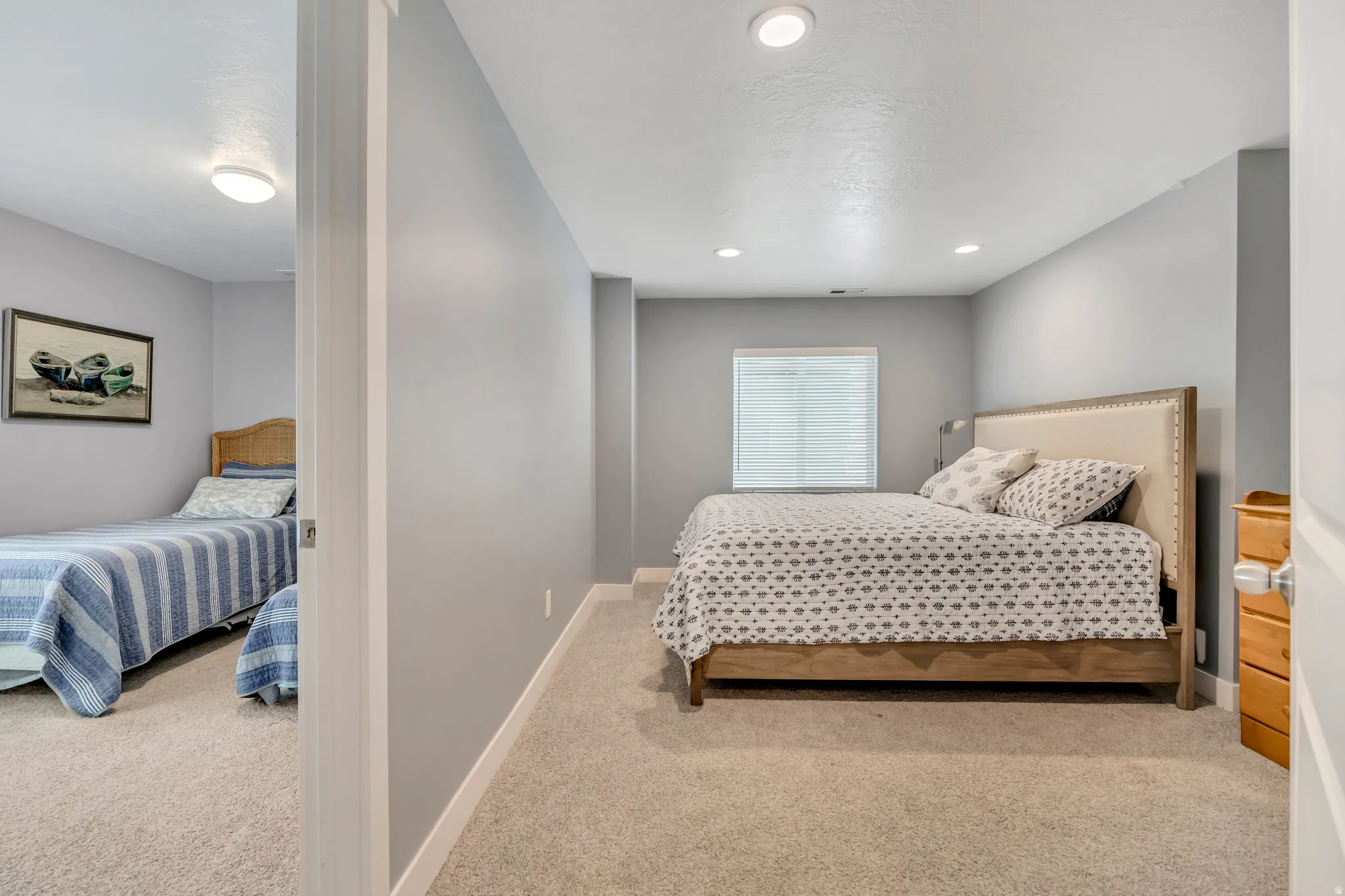 Bedroom with light carpet and recessed lighting