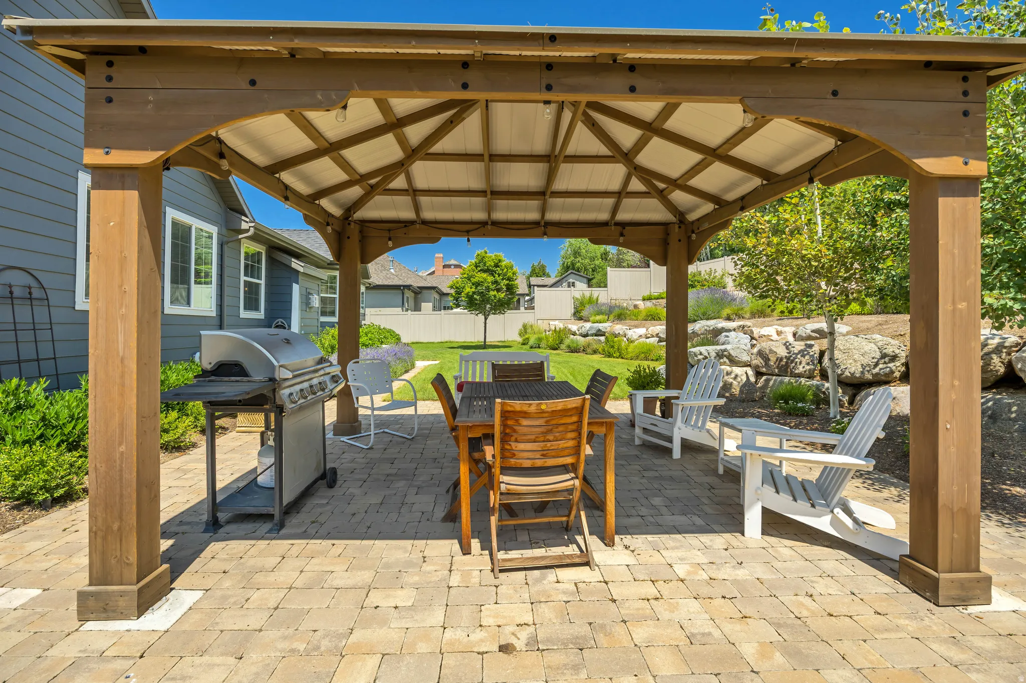 View of patio / terrace featuring a gazebo, outdoor dining area, a grill, and a residential view