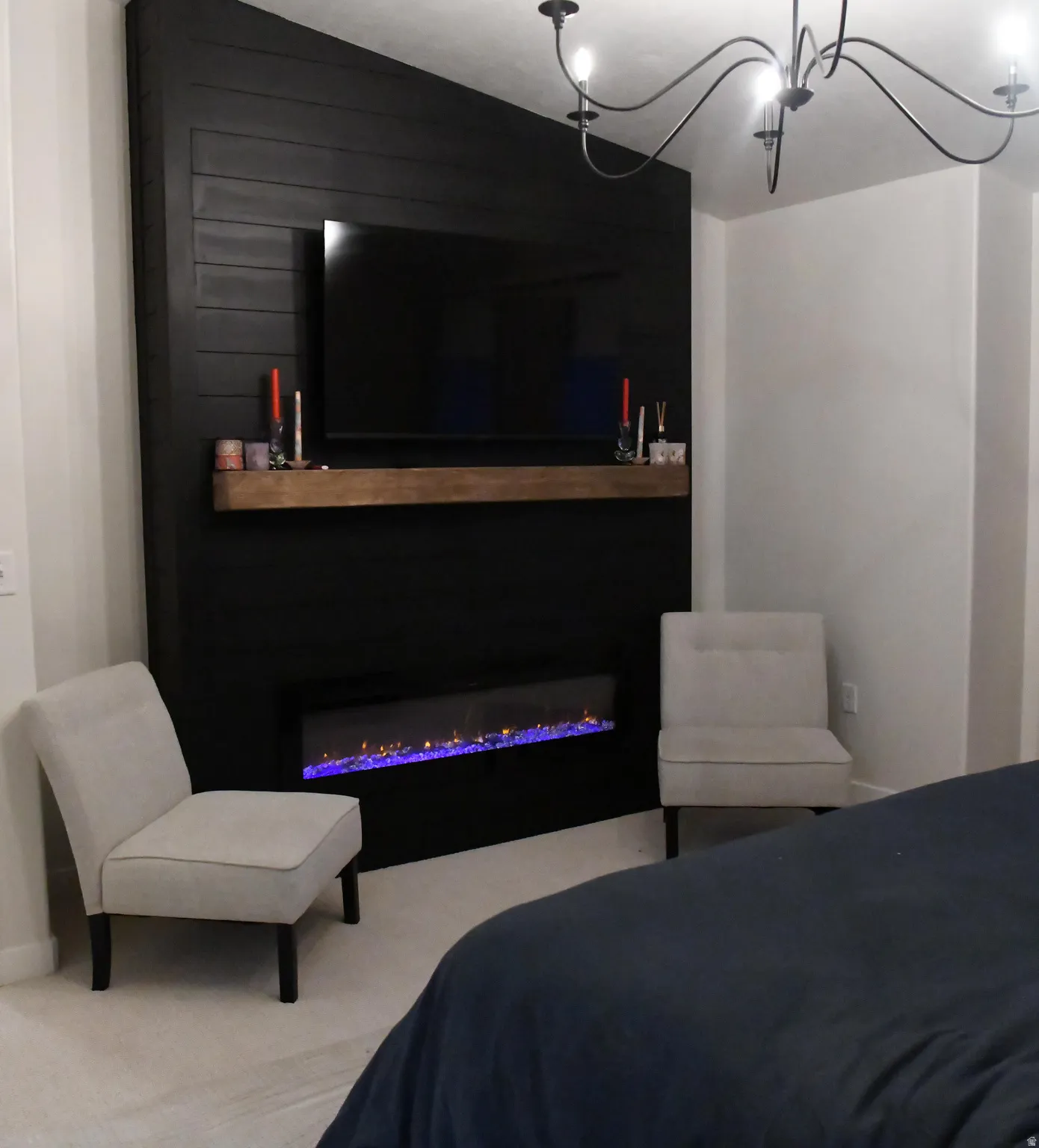 Carpeted bedroom featuring a glass covered fireplace