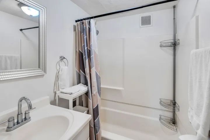 Full bathroom featuring shower / bath combo with shower curtain and vanity.