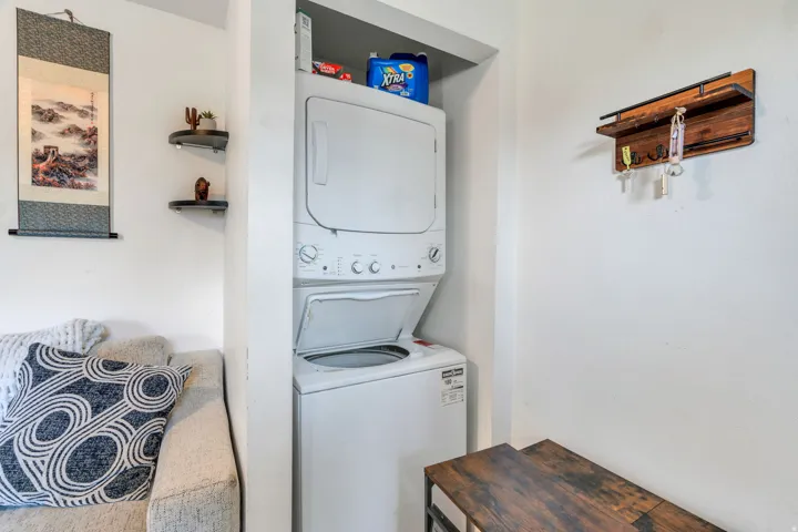 Laundry area with stacked washer / drying machine.