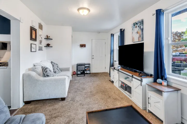 Living room with light colored carpet.