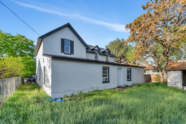 Rear view of property featuring stucco siding.