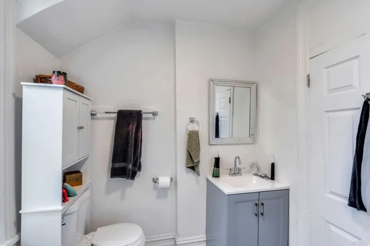 Half bathroom featuring toilet and vanity.