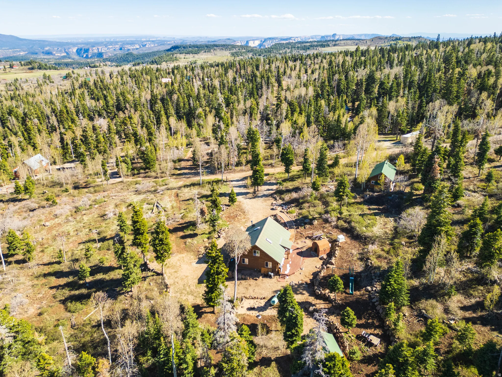 High-Altitude Perspective: Wide aerial shot showing the cabin’s position on the Kolob plateau.