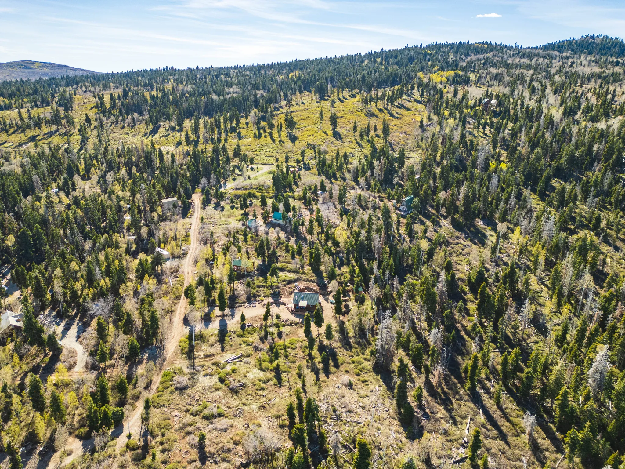Epic Skyline Views: Wide-angle drone shot highlighting the vast blue skies and mountain ridges.