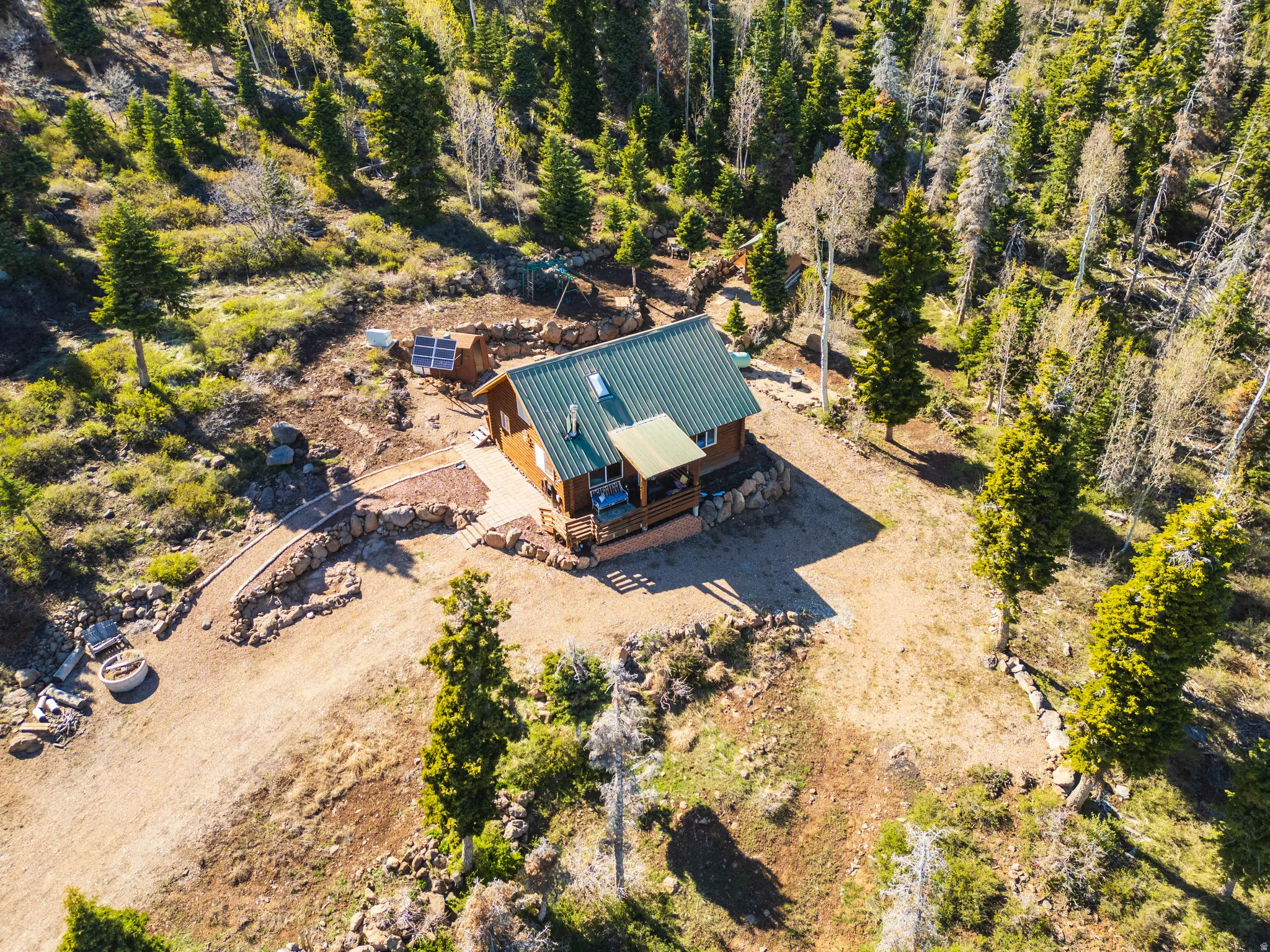 Top-Down Site View: Shows the strategic placement of the cabin and outbuildings on the lot.