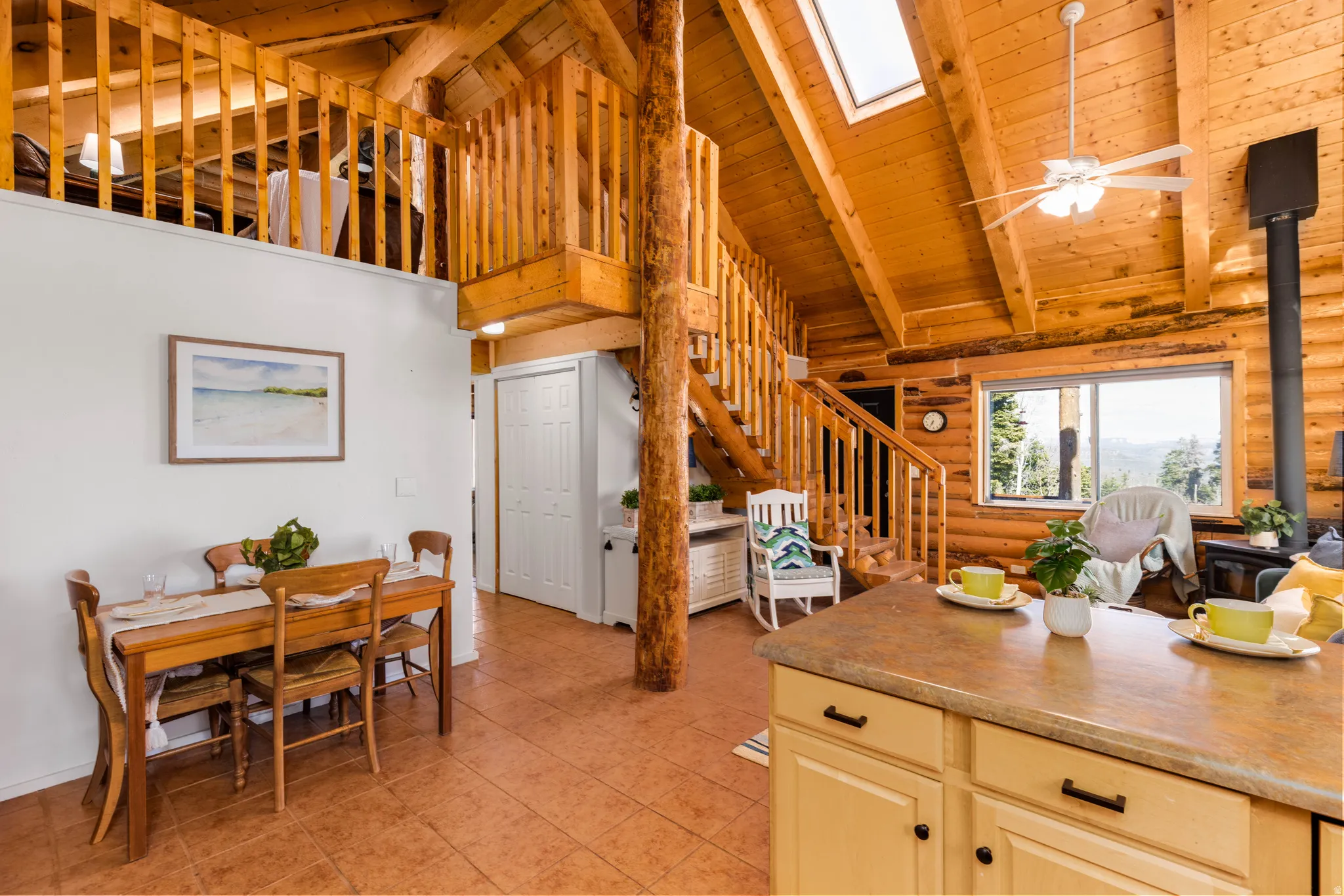Loft Access & Dining: View of the custom staircase leading to the expansive second-story loft.