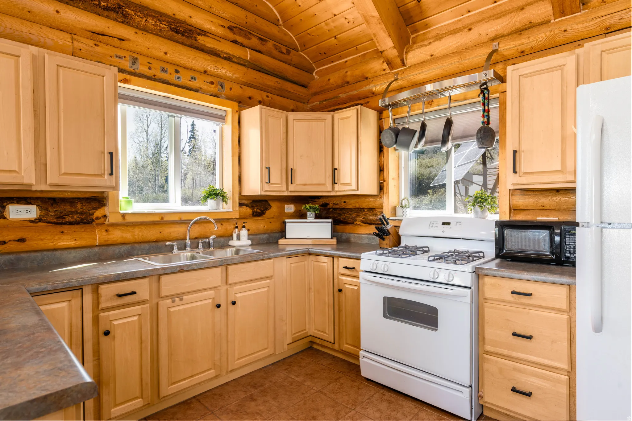 Kitchen Detail: Bright and functional kitchen space with beautiful log wall accents.