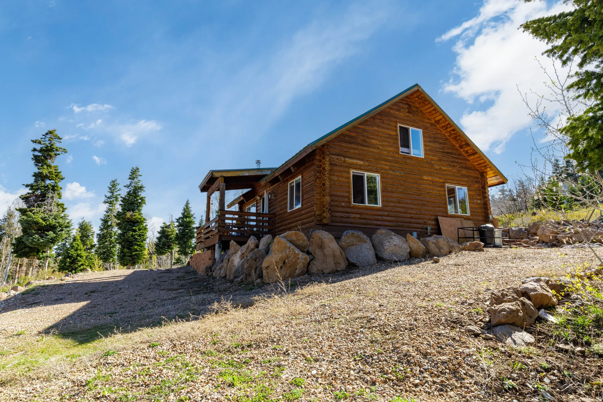 Stone Foundation Detail: Quality craftsmanship is evident in the stone-clad foundation and site prep.