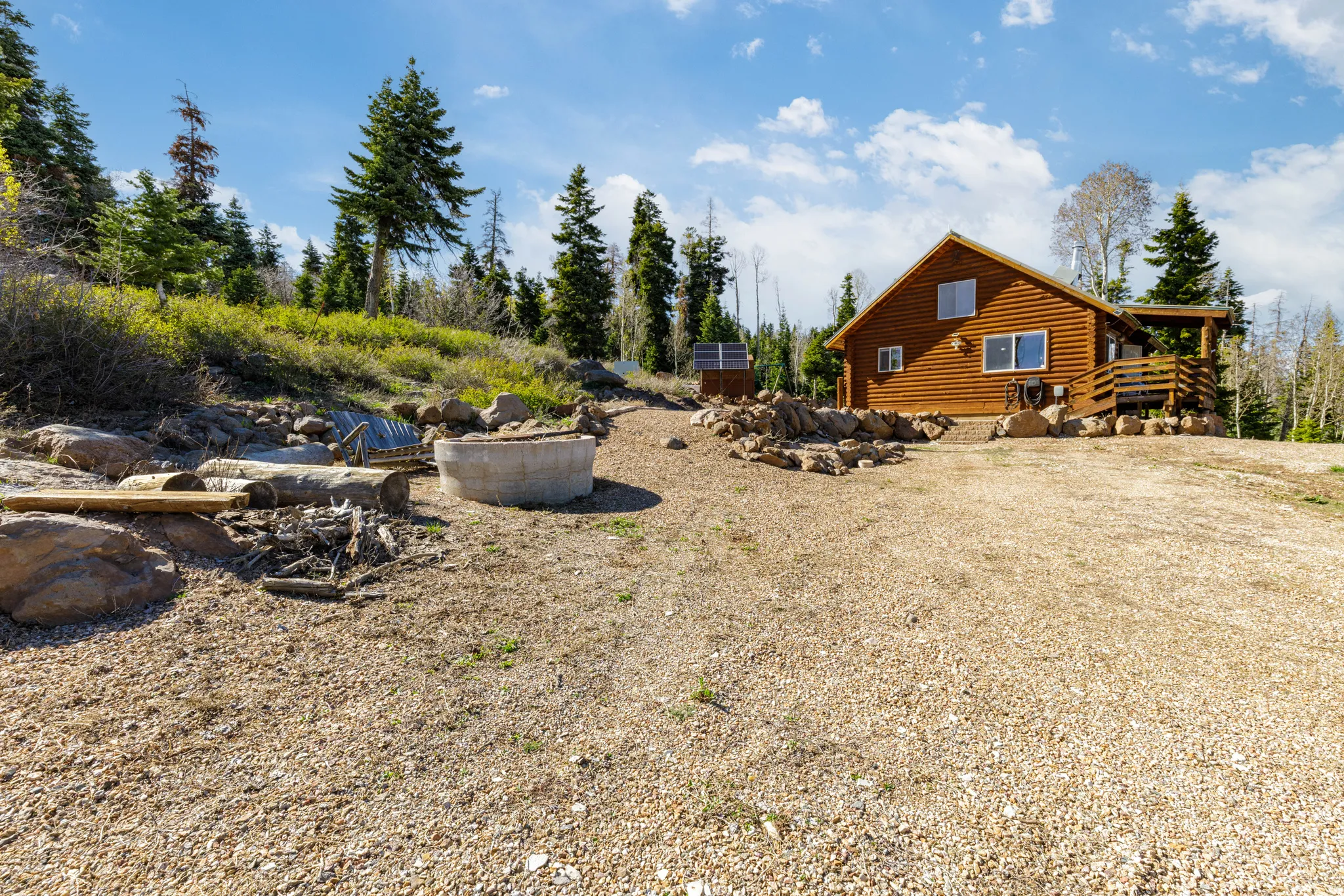 Cleared Entry Space: Wide-open space at the front of the cabin for parking and access.