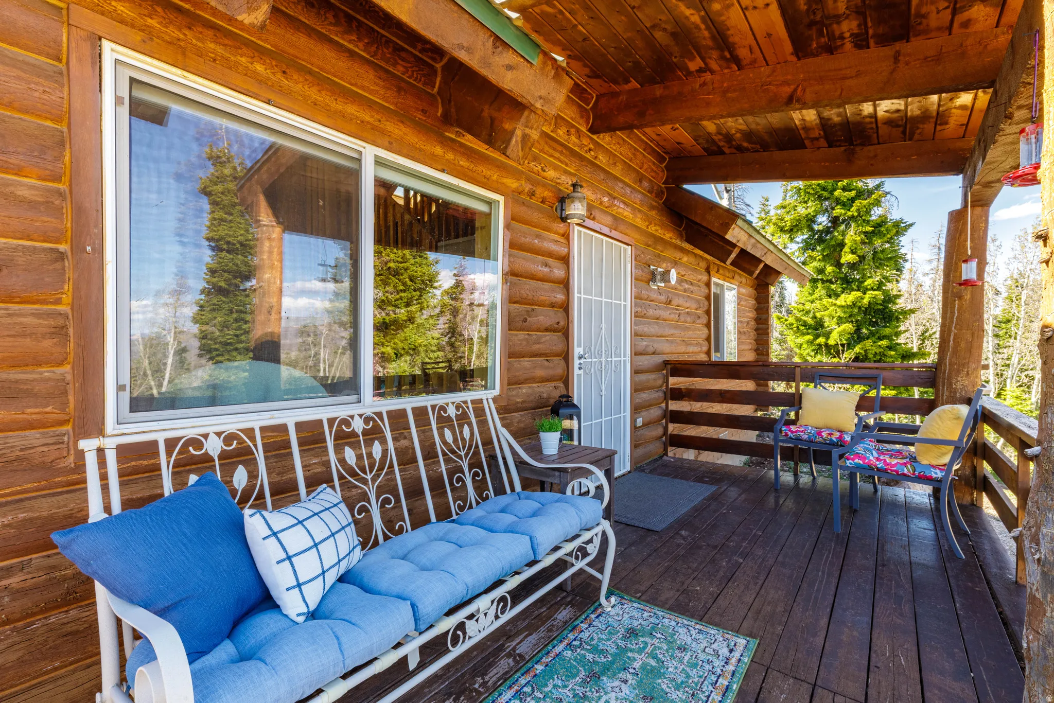 Covered Porch Lounge: Relax on the covered portion of the wrap-around deck with comfortable seating.